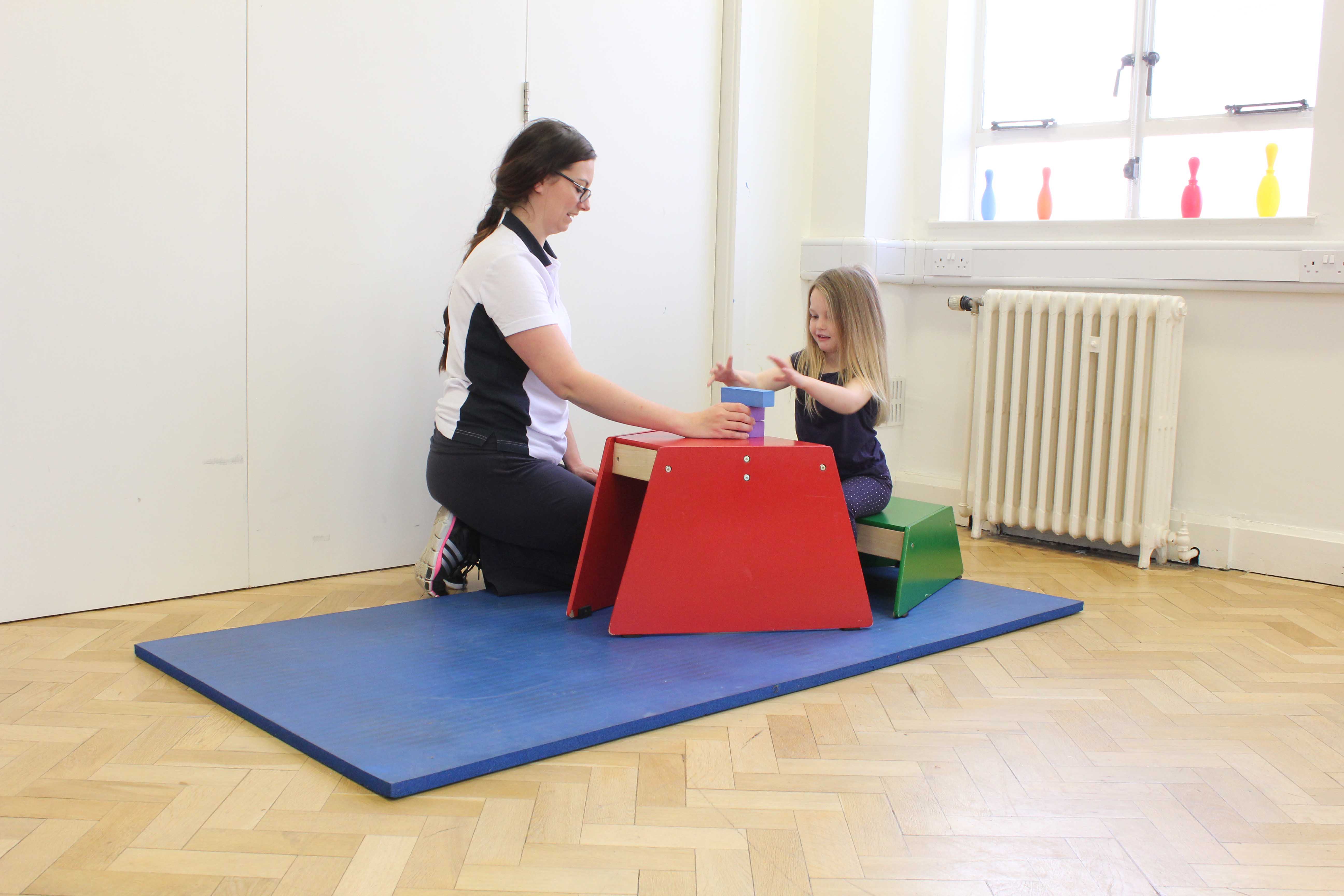 Functional fine motor skill exercises supervised by a neurological paediatric physiotherapist