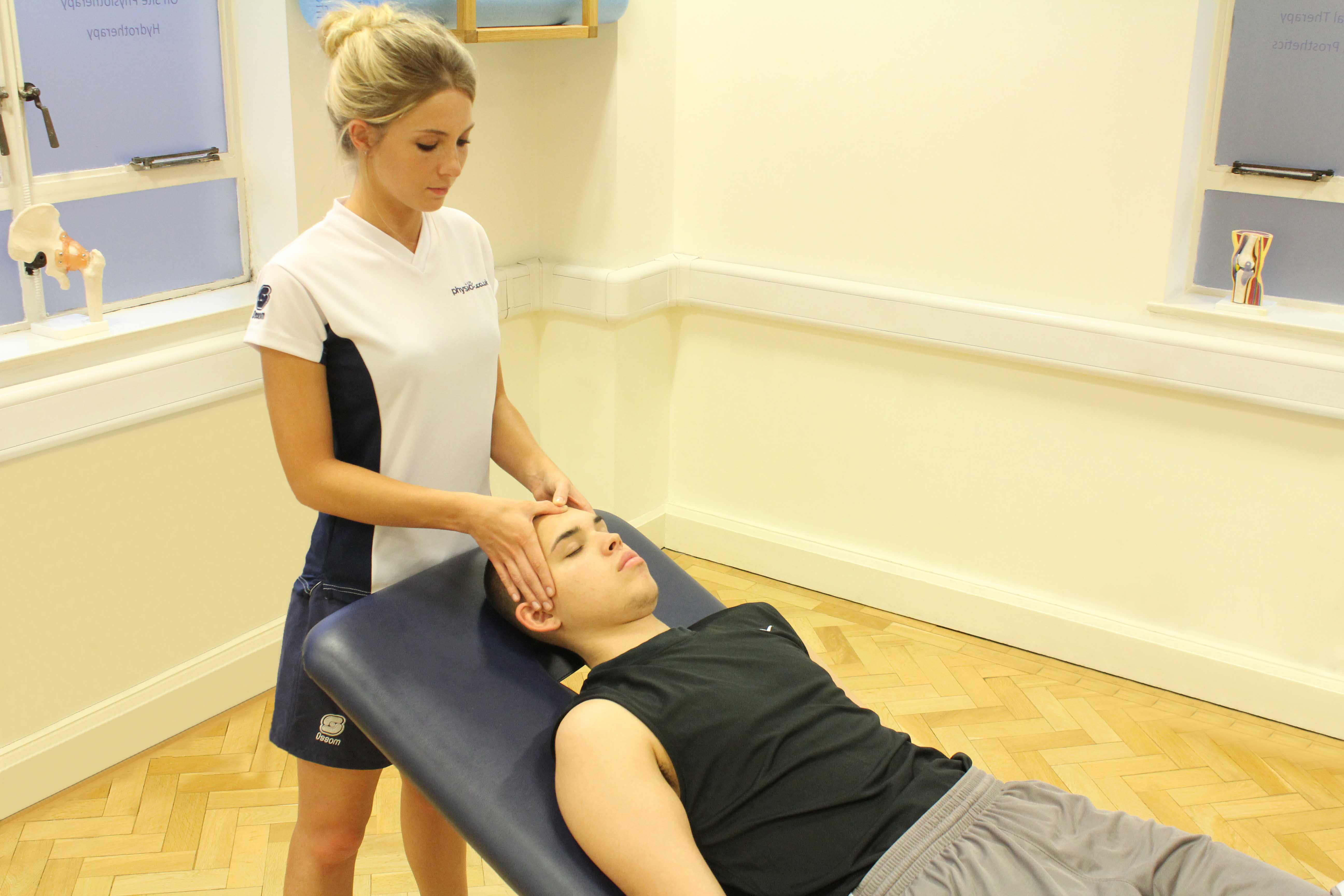 Soft tissue massage of head and face to releive stiffness and stimulate neurological repair