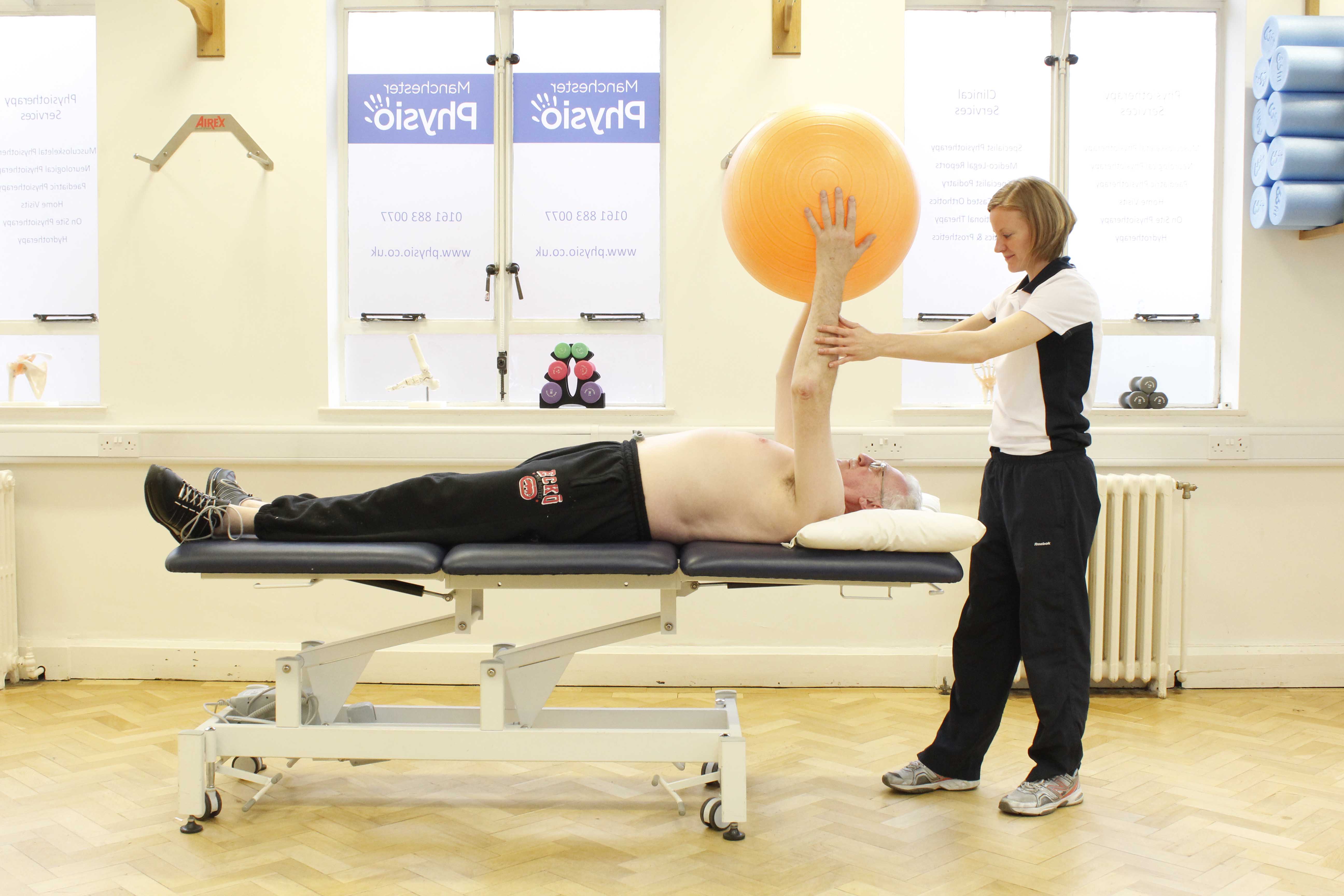 Upper limb mobility exercises using a gym ball assisted by a physiotherapist