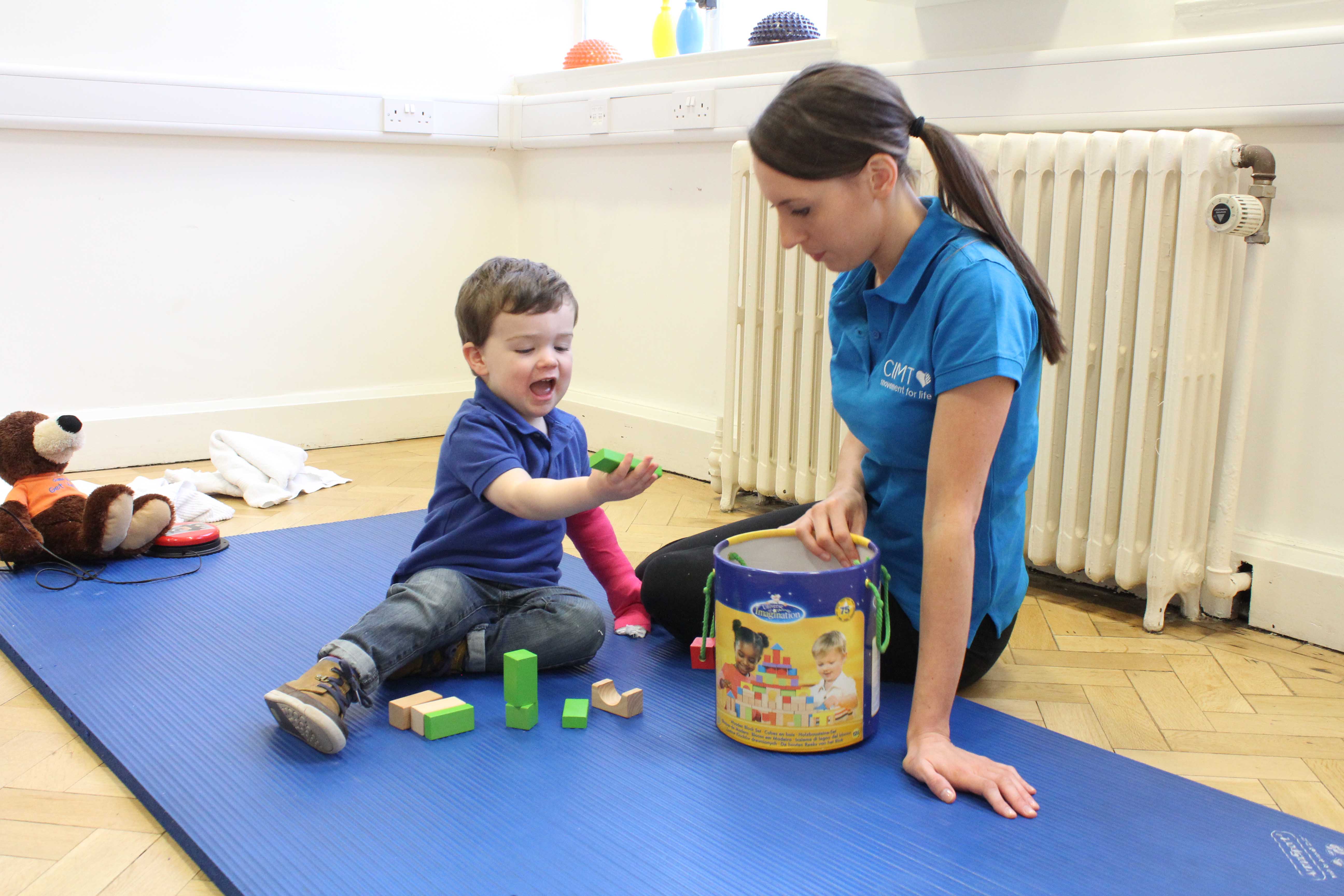 Equalising the development of fine motor skills by constraining the dominant limb and engaging with structured play