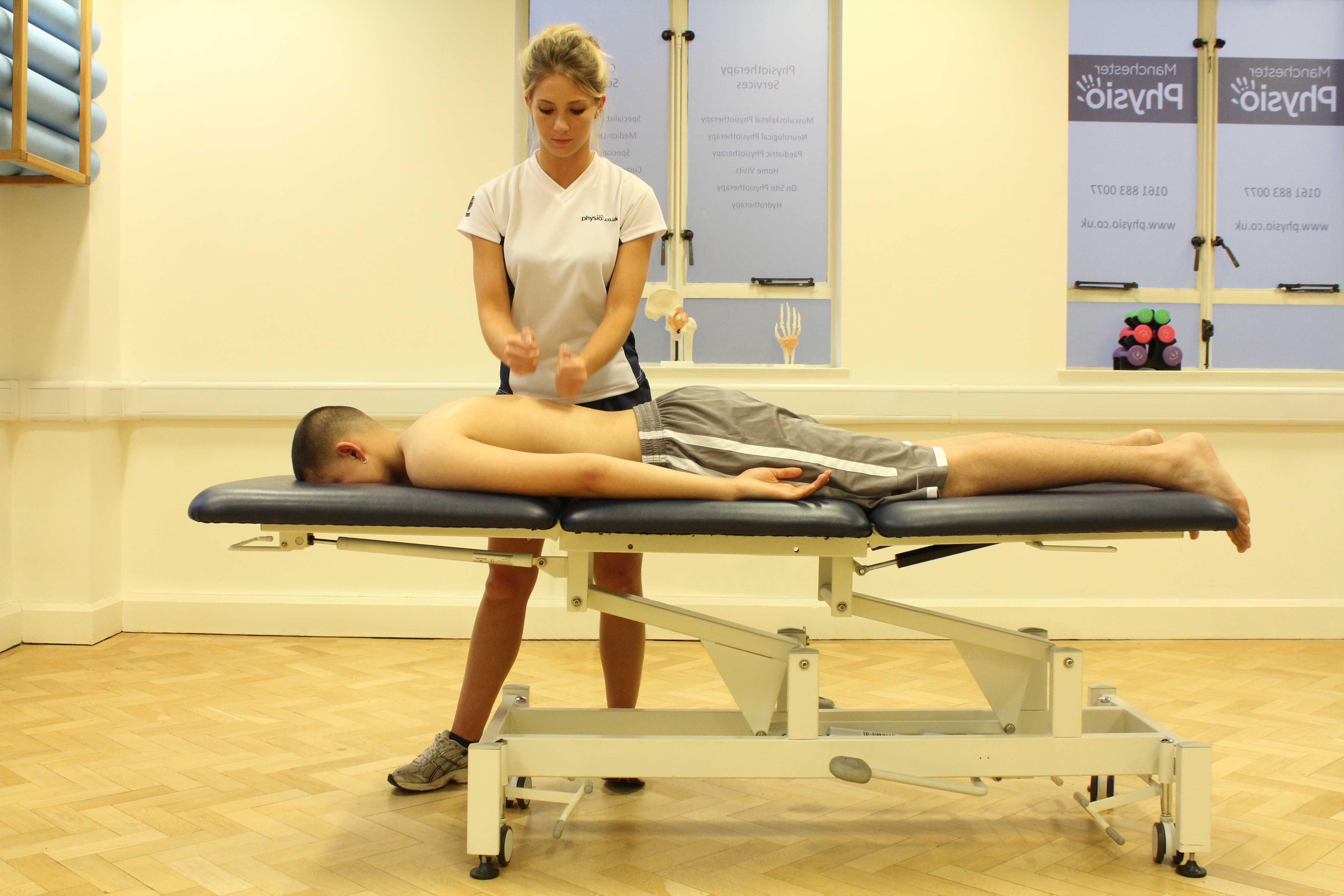 Percussion massage applied to the mid thoracic spine
