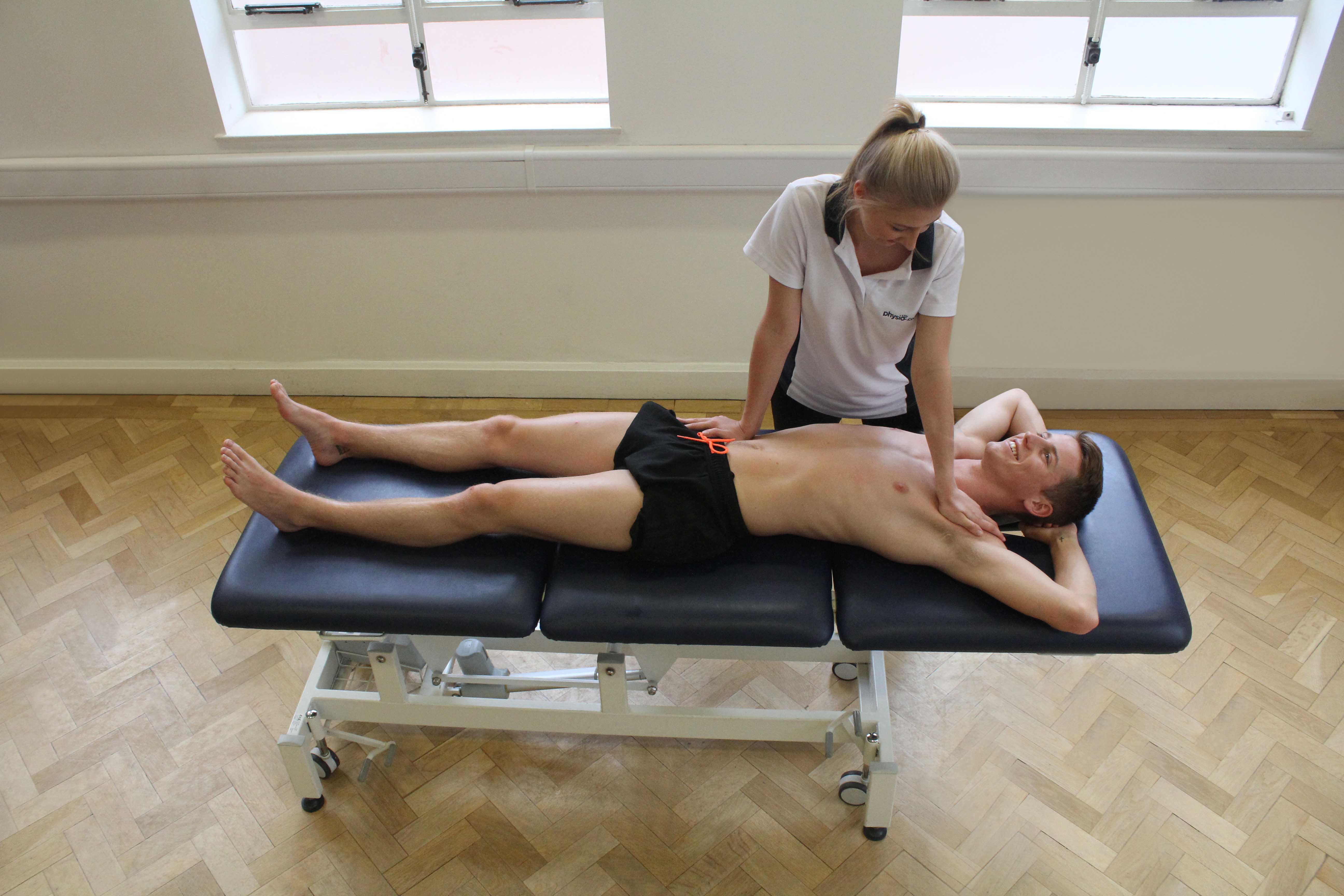 Soft tissue massage of the abdominal muscles by an experienced therapist
