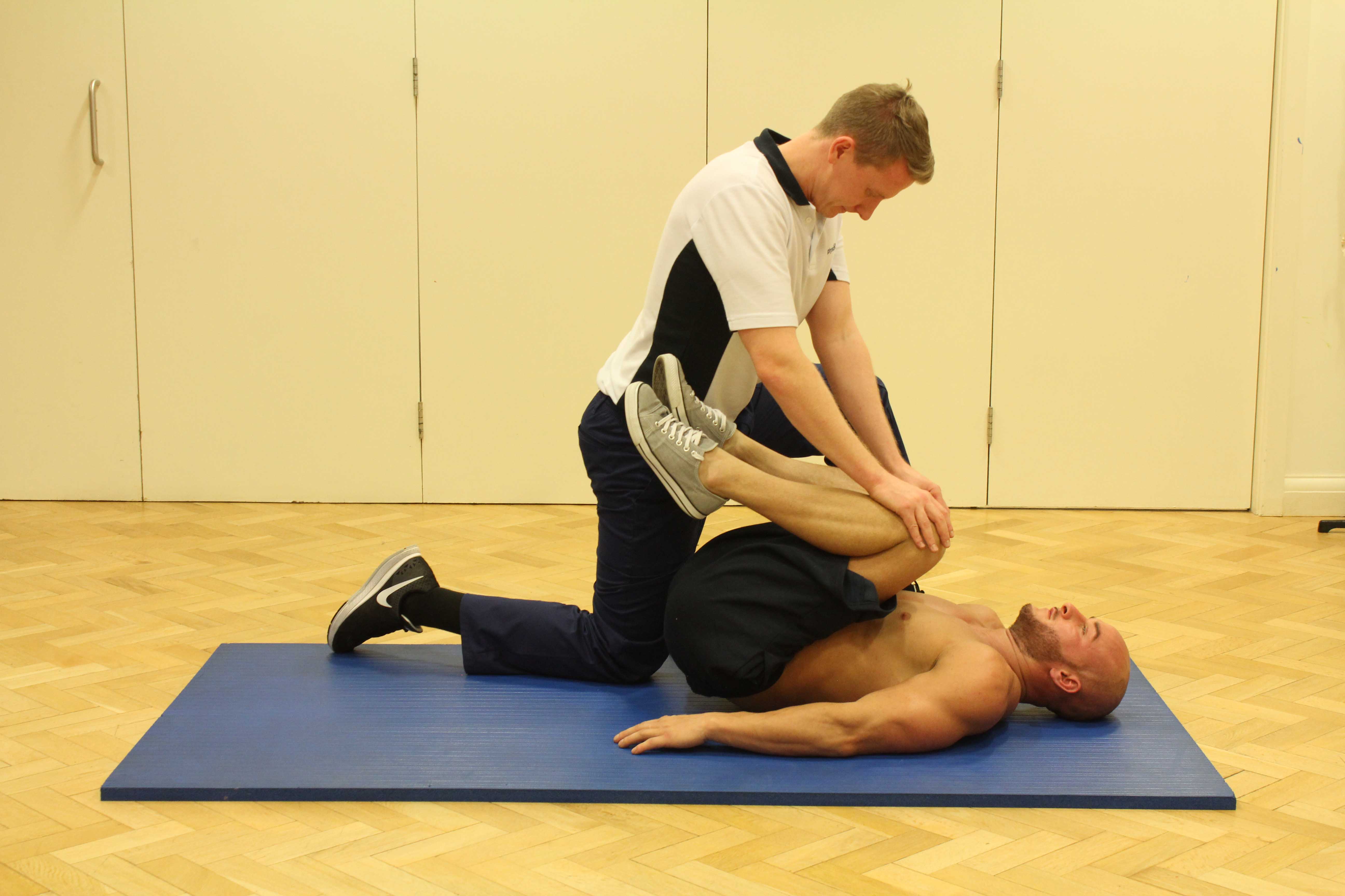 Passive stretch of the lower back muscles performed by MSK physiotherapist
