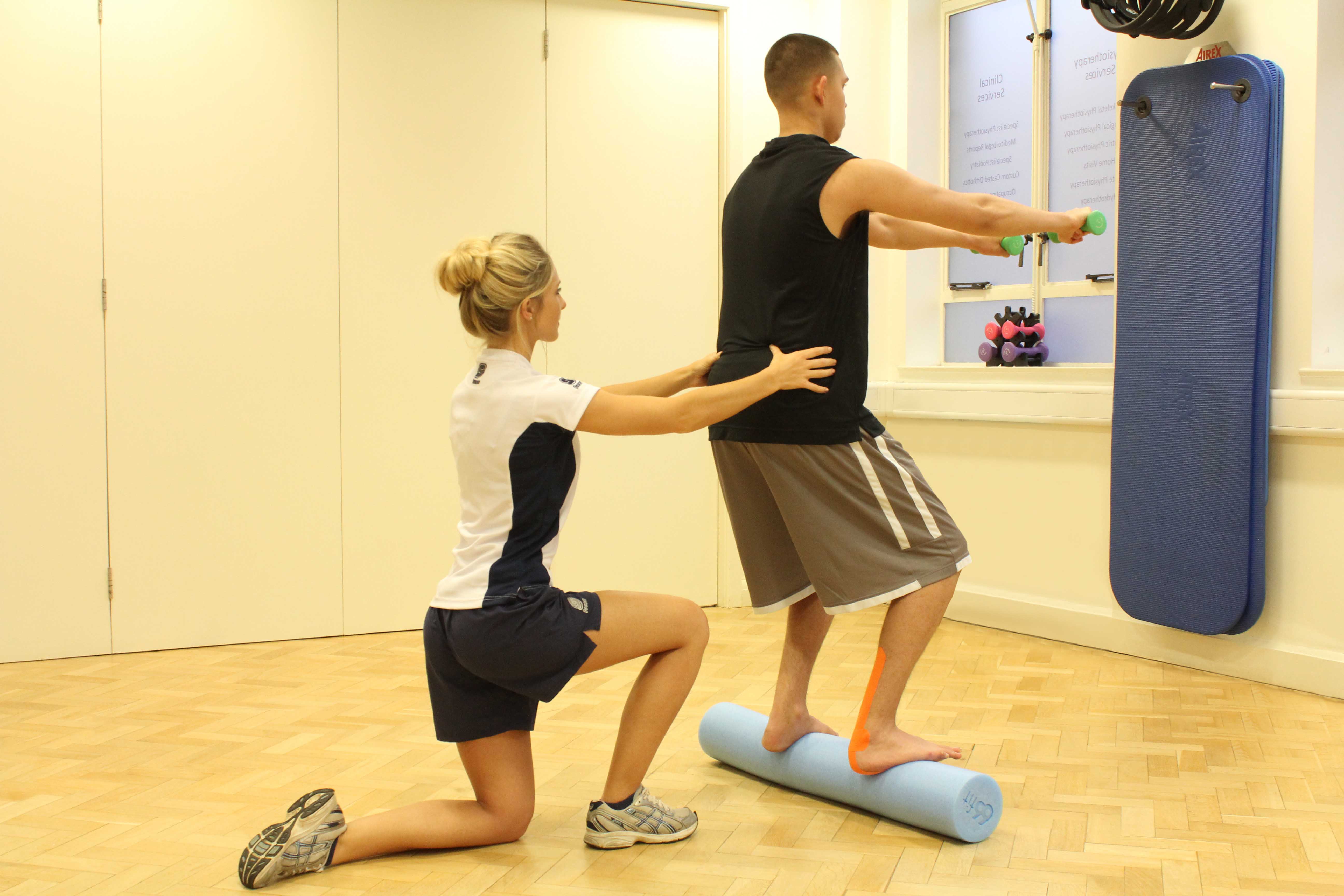 Ankle stability exercises, with supportive tape, supervised by therapist