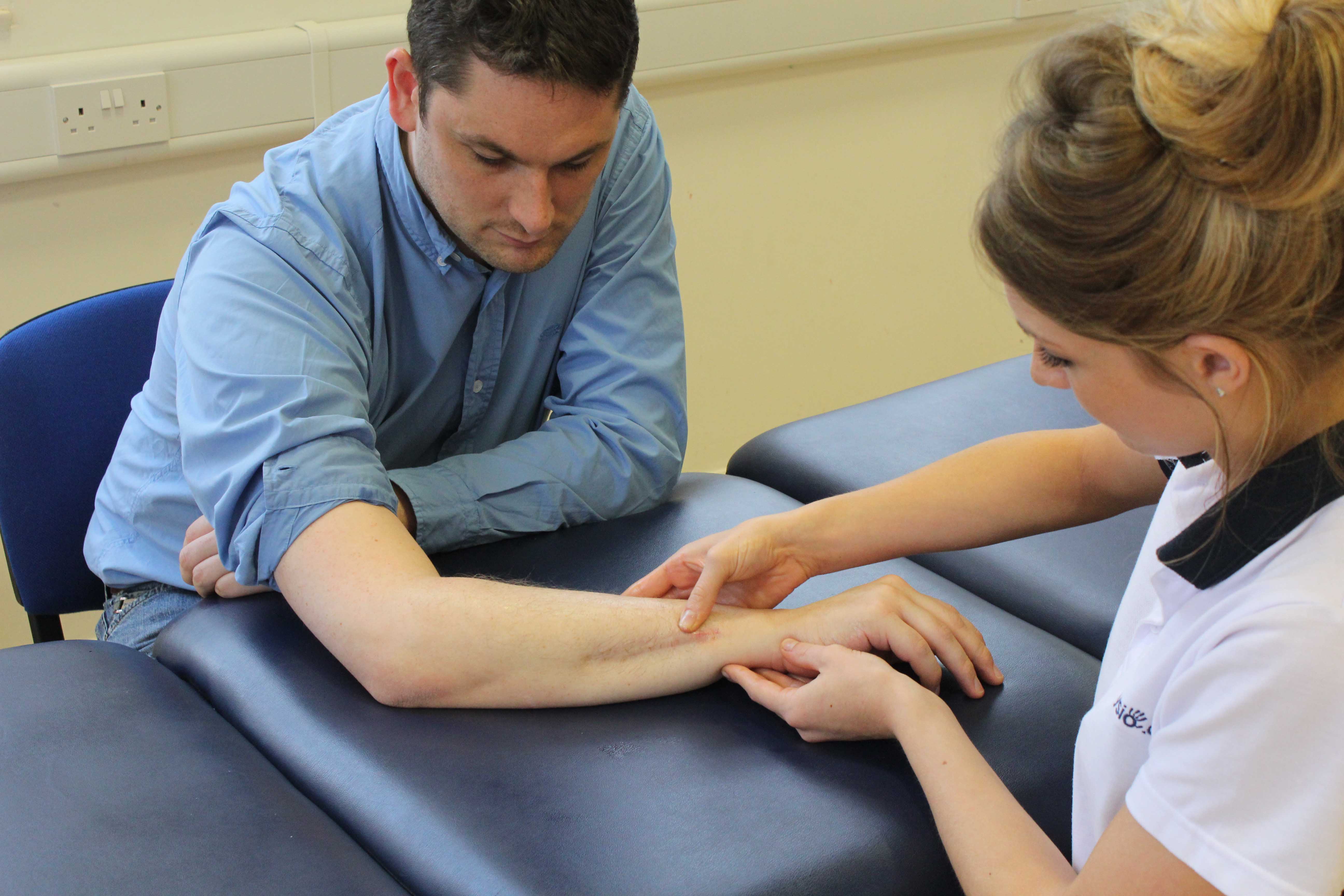 Therapist examination of wrist healing following a fracture