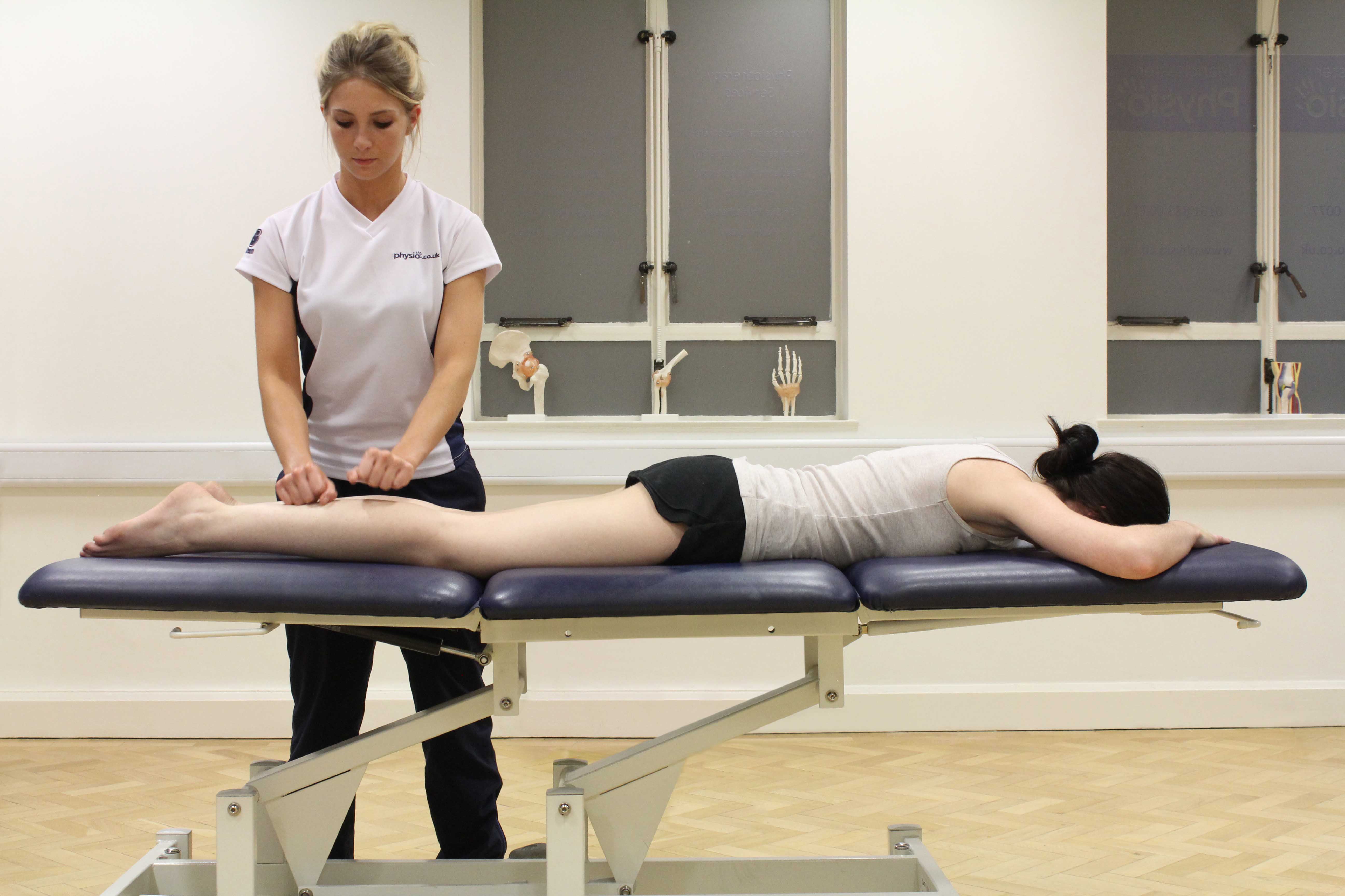 Beating percussion massage applied to the gastrocnemius muscle by experienced therapist