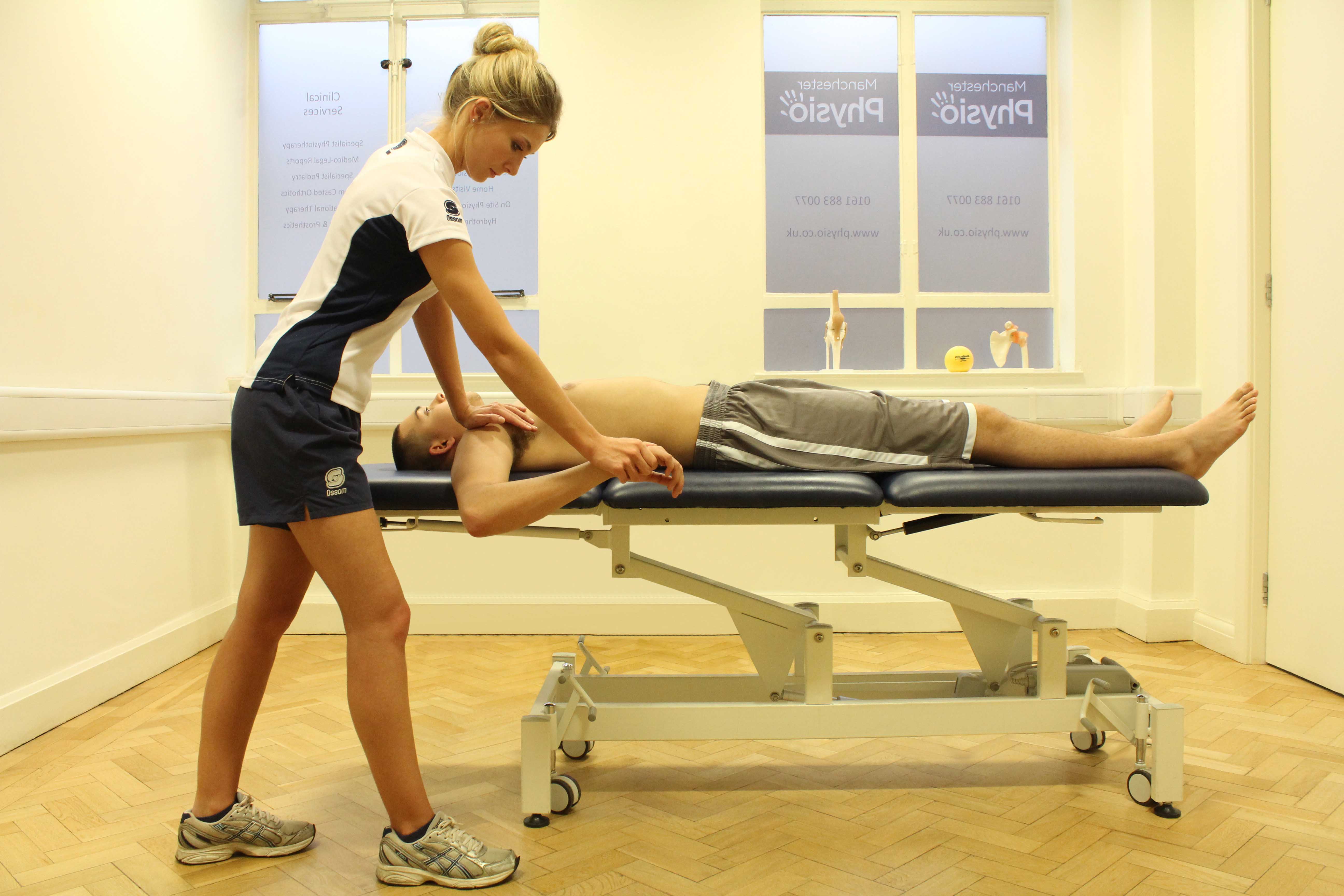 Examination of finger hyperextension injury by experienced physiotherapist