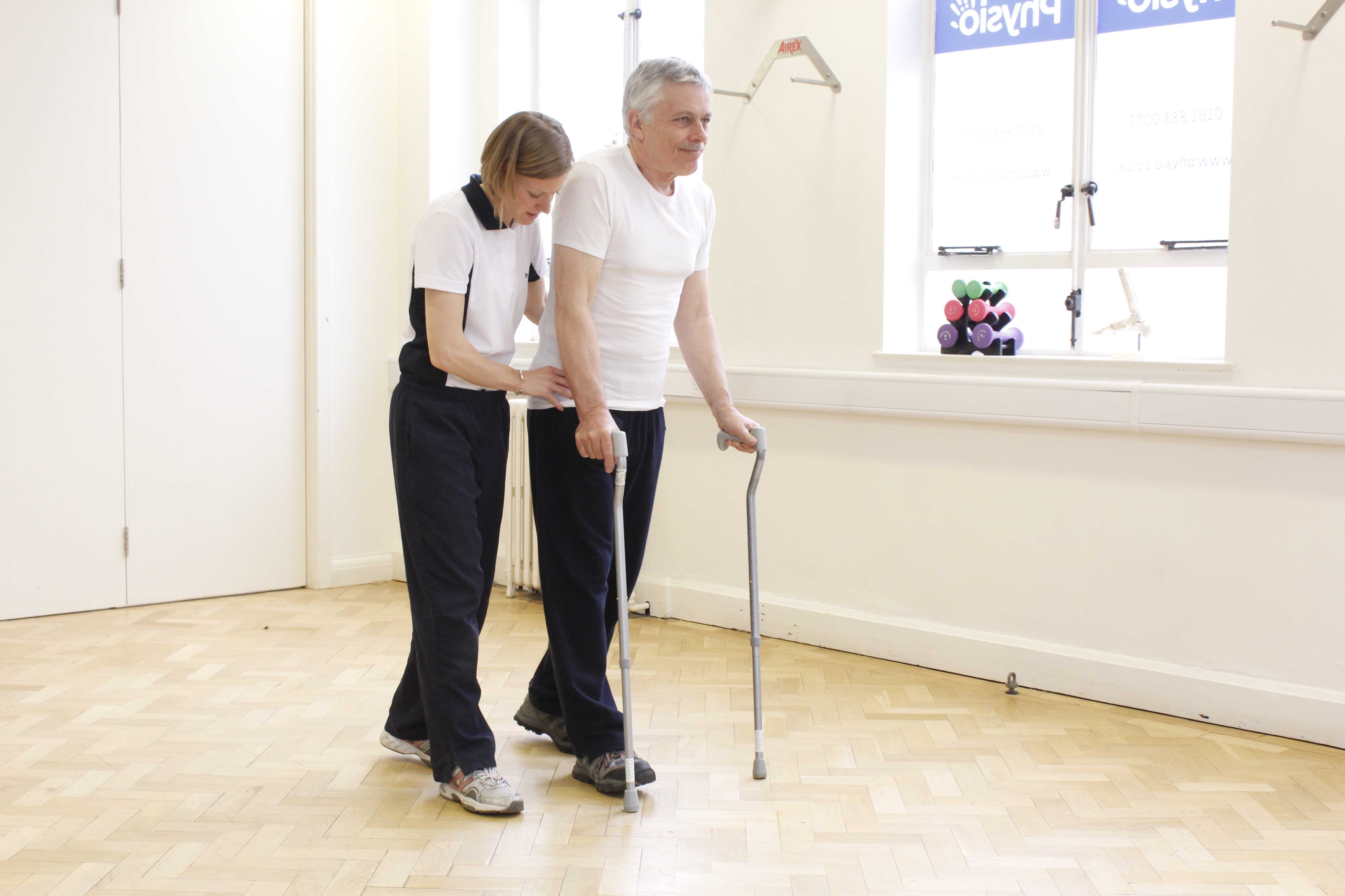 Mobility exercises using two walking sticks and close supervision of a physiotherapist