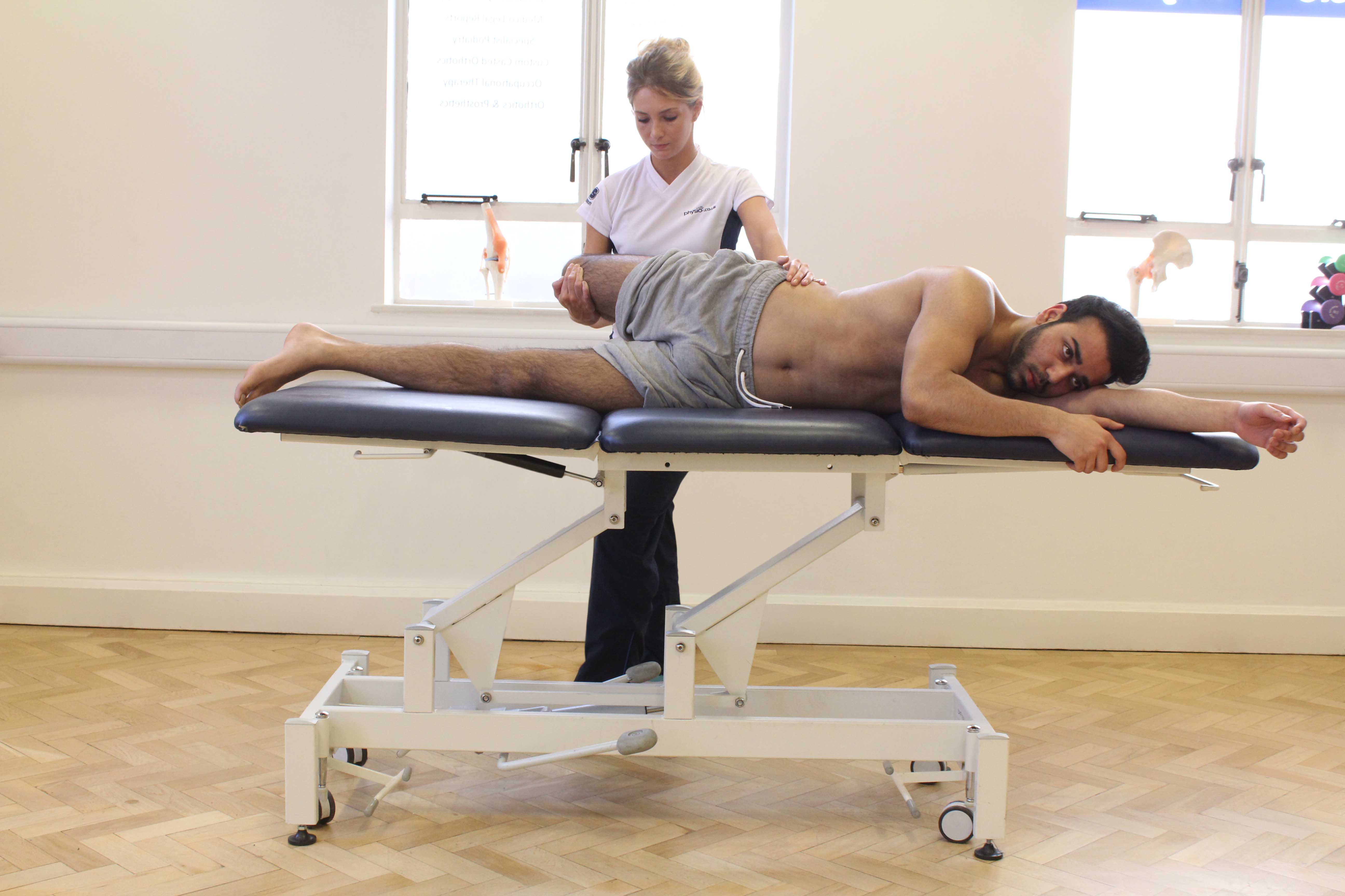 Therapist applying stretch to hip flexor and quad muscle groups