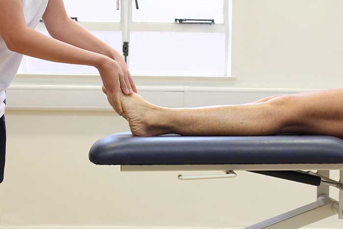 Customer receiving foot massage in relaxed position in Manchester Physio Clinic