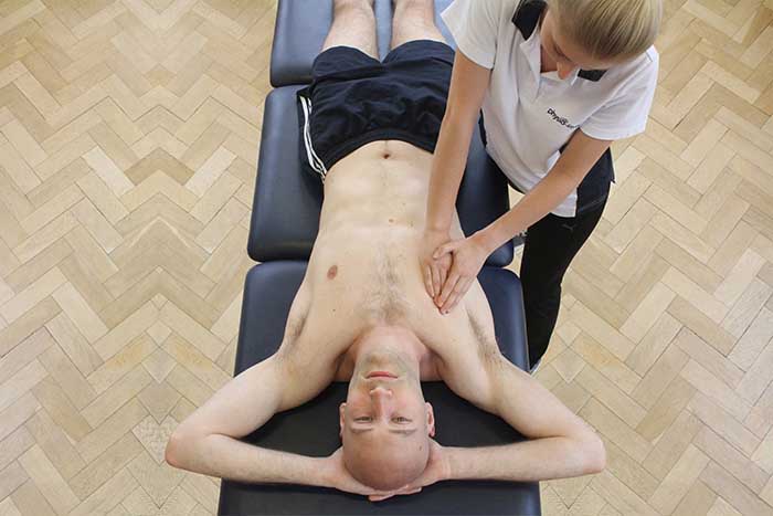 Customer reciving chest massage while in relaxed position in Manchester Physio Clinic