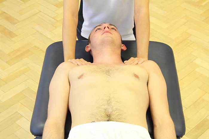 Customer reciving chest massage while in relaxed position in Manchester Physio Clinic