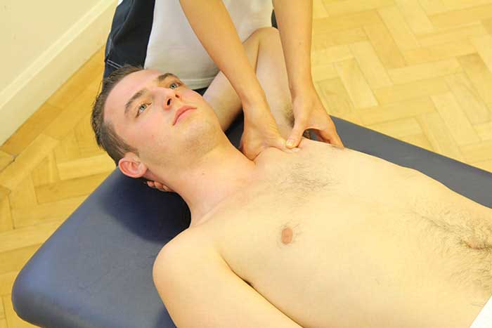 Customer receiving upper shoulder massage in Manchester Physio Clinic
