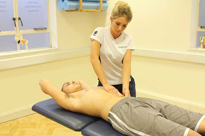 Customer receiving abdominal massage while in a relaxed position