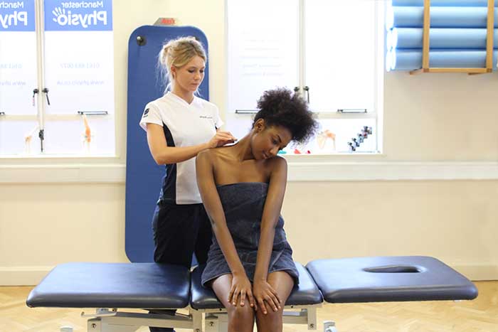 Customer receiving a shoulder massage while in a sitting position 
