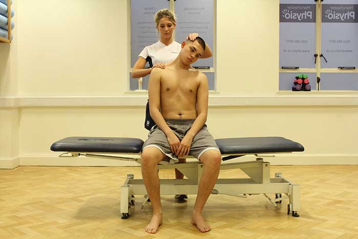 Customer receiving a neck stretch while in a sitting up position in Manchester Physio Clinic