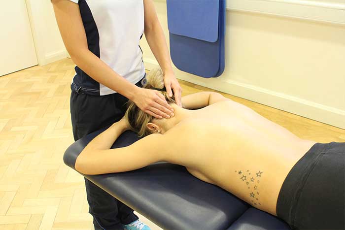 Customer receiving head massage in relaxed position in Manchester Physio Clinic