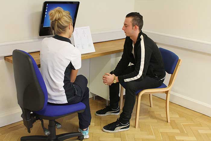 Customer receiving after session guidance from instructor in Manchester Physio Clinic