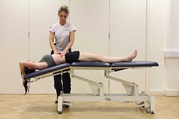 Customer receiving abdominal stretches while given massage in Manchester Physio Clinic