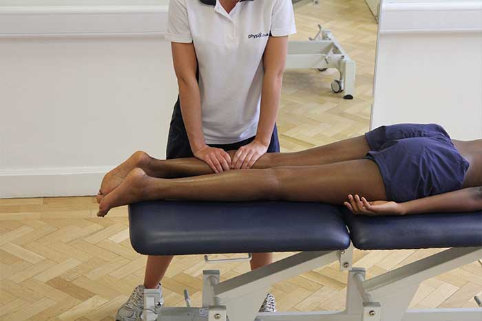Customer receiving lower leg massage while in relaxed position in Manchester Physio Clinic