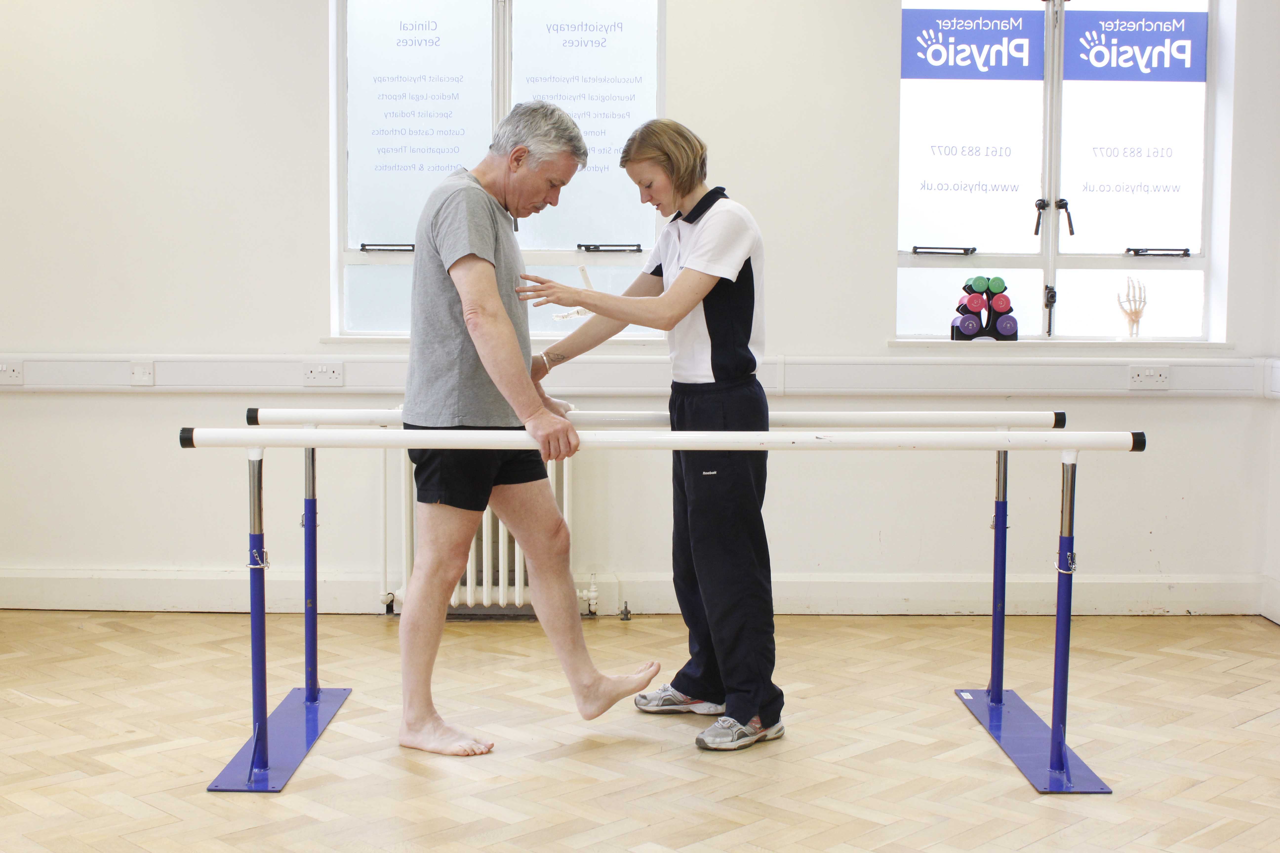 Mobility exercises between the parallel bars assisted by specialist neurological physiotherapist