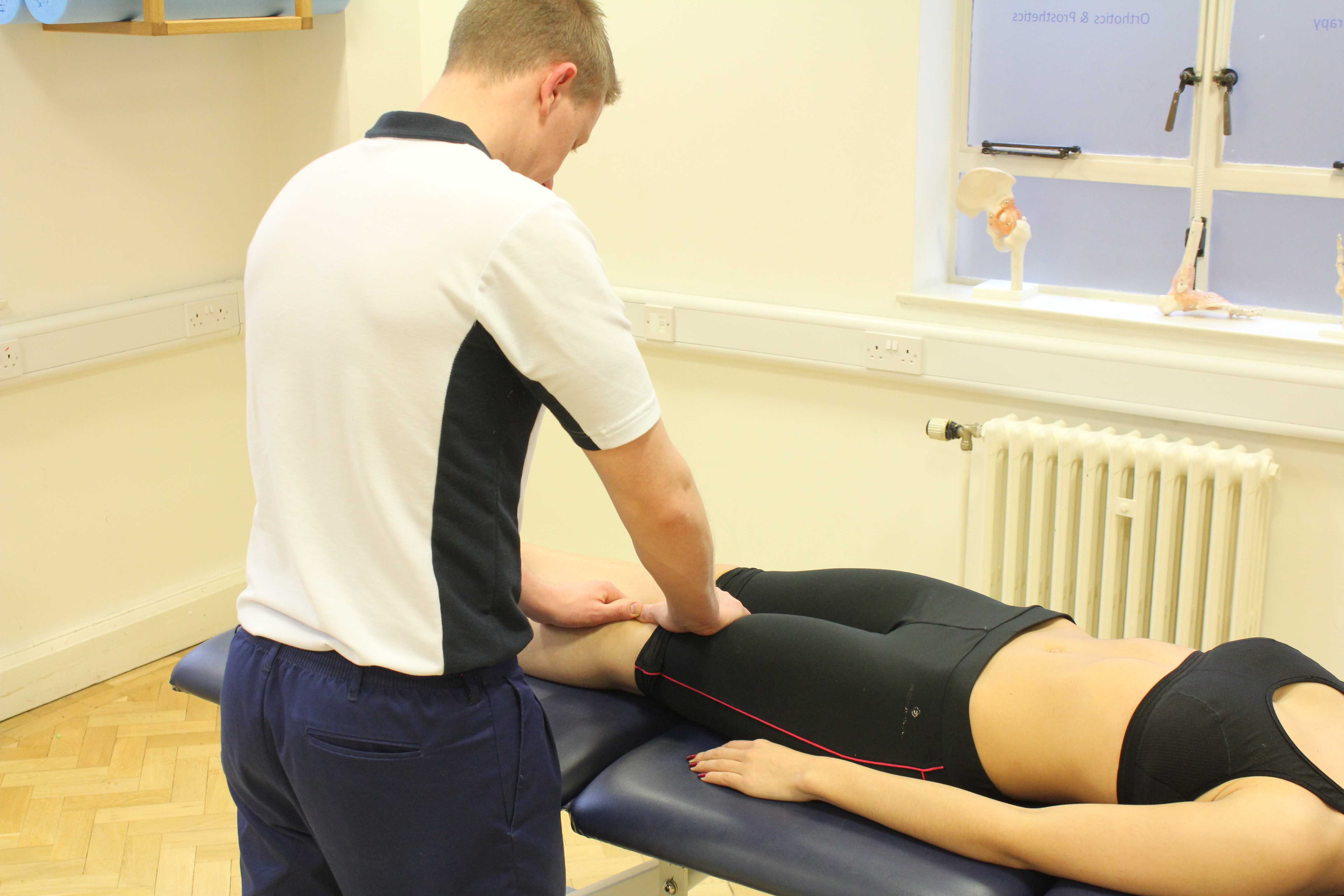 Therapist performing mobilisations on the patella, knee joint and surrounding connective tissue.
