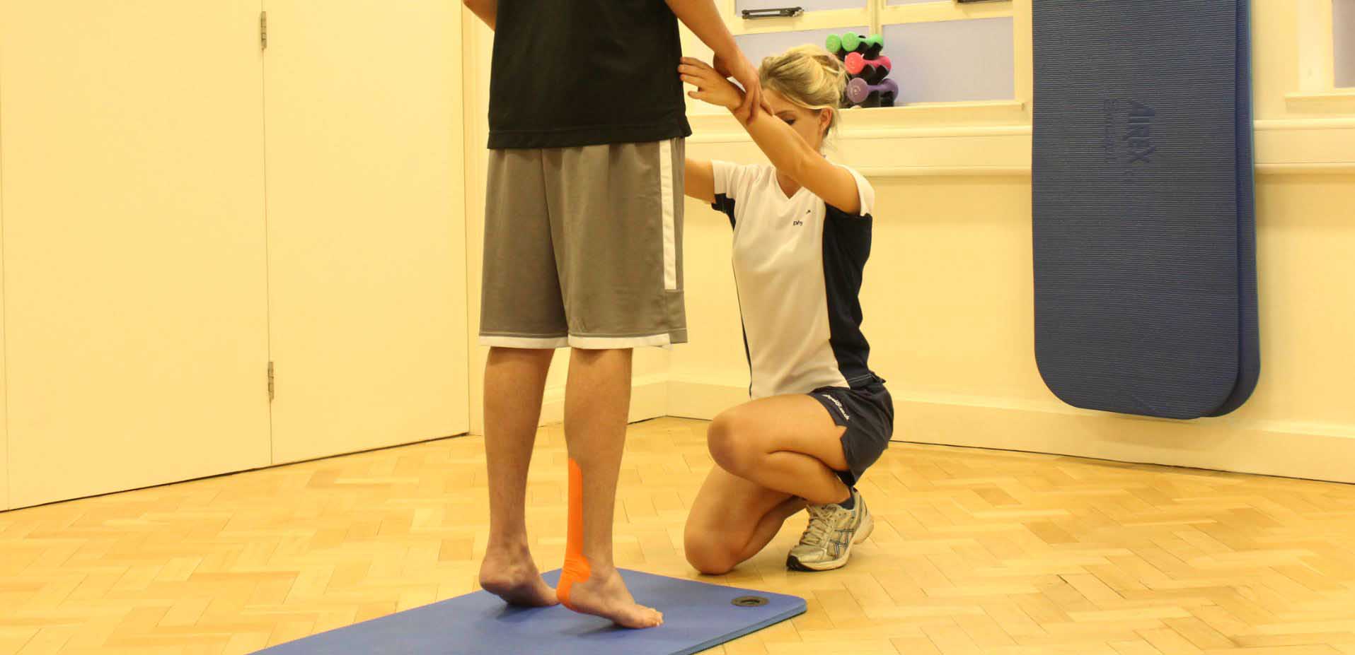 Supportive tape applied to ankle by experienced therapist