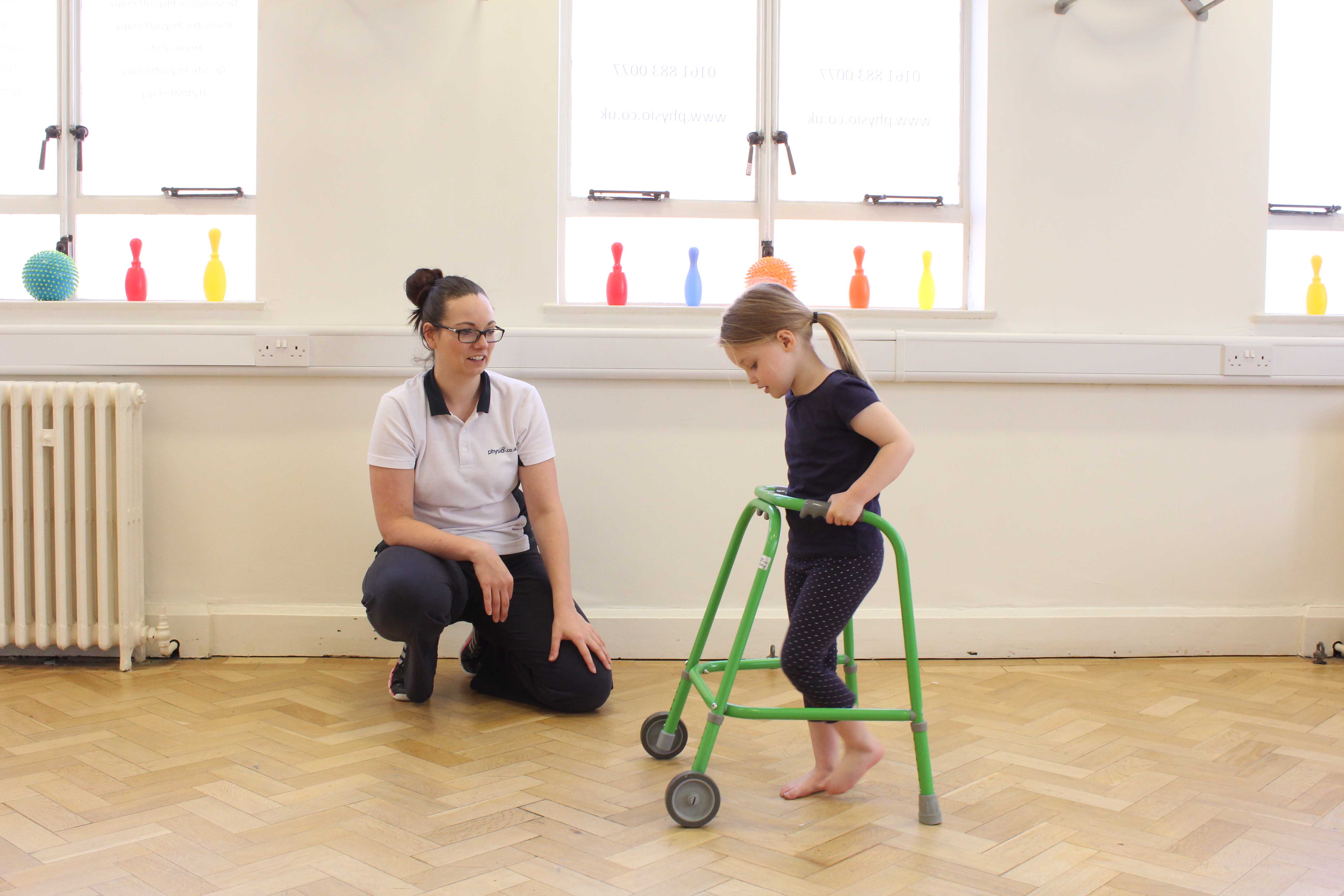 Mobility exercises using a wheeled walking frame under supervision of a paediatric physiotherapist