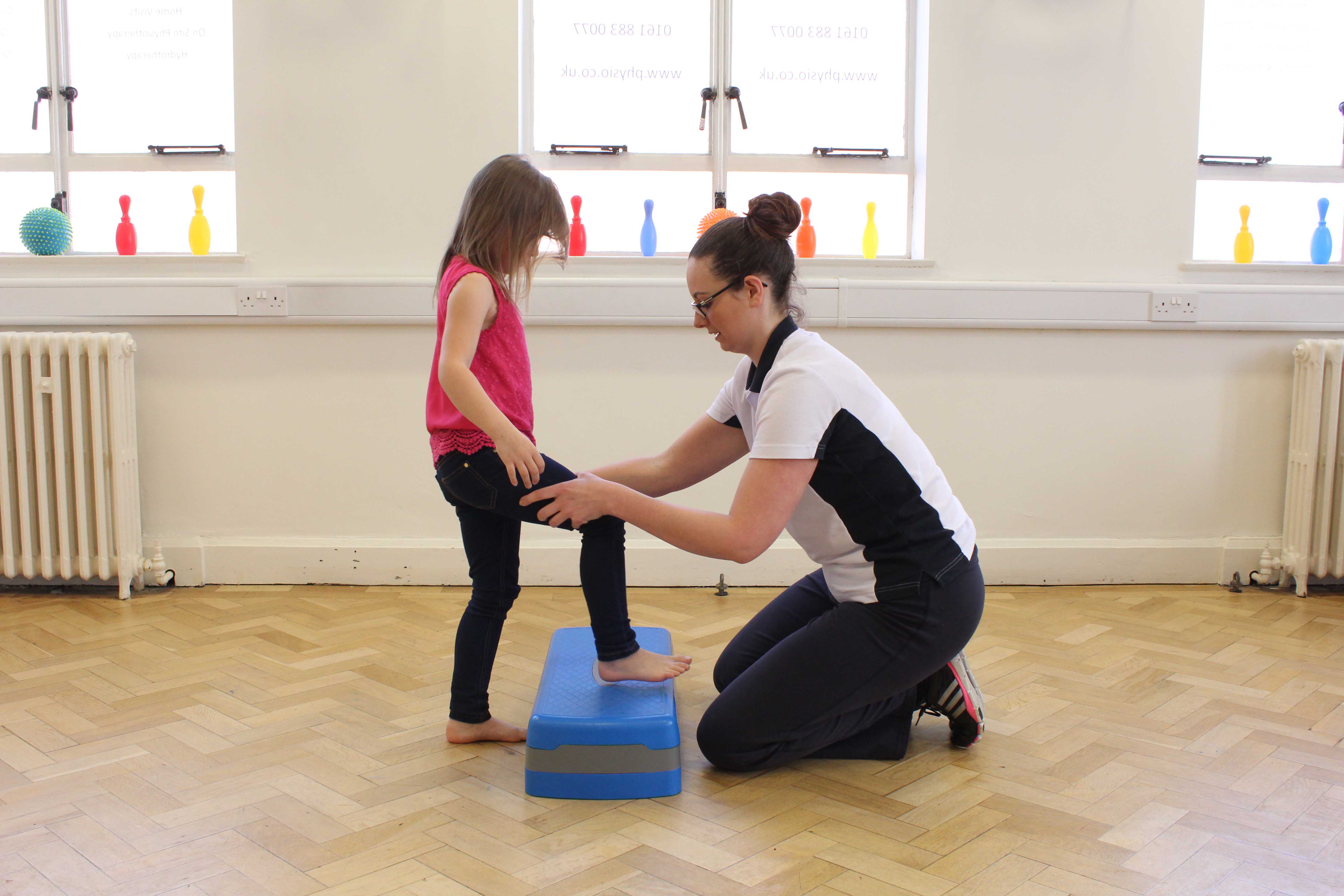 Functional mobility exercises assisted by a paediatric neuro physiotherapist