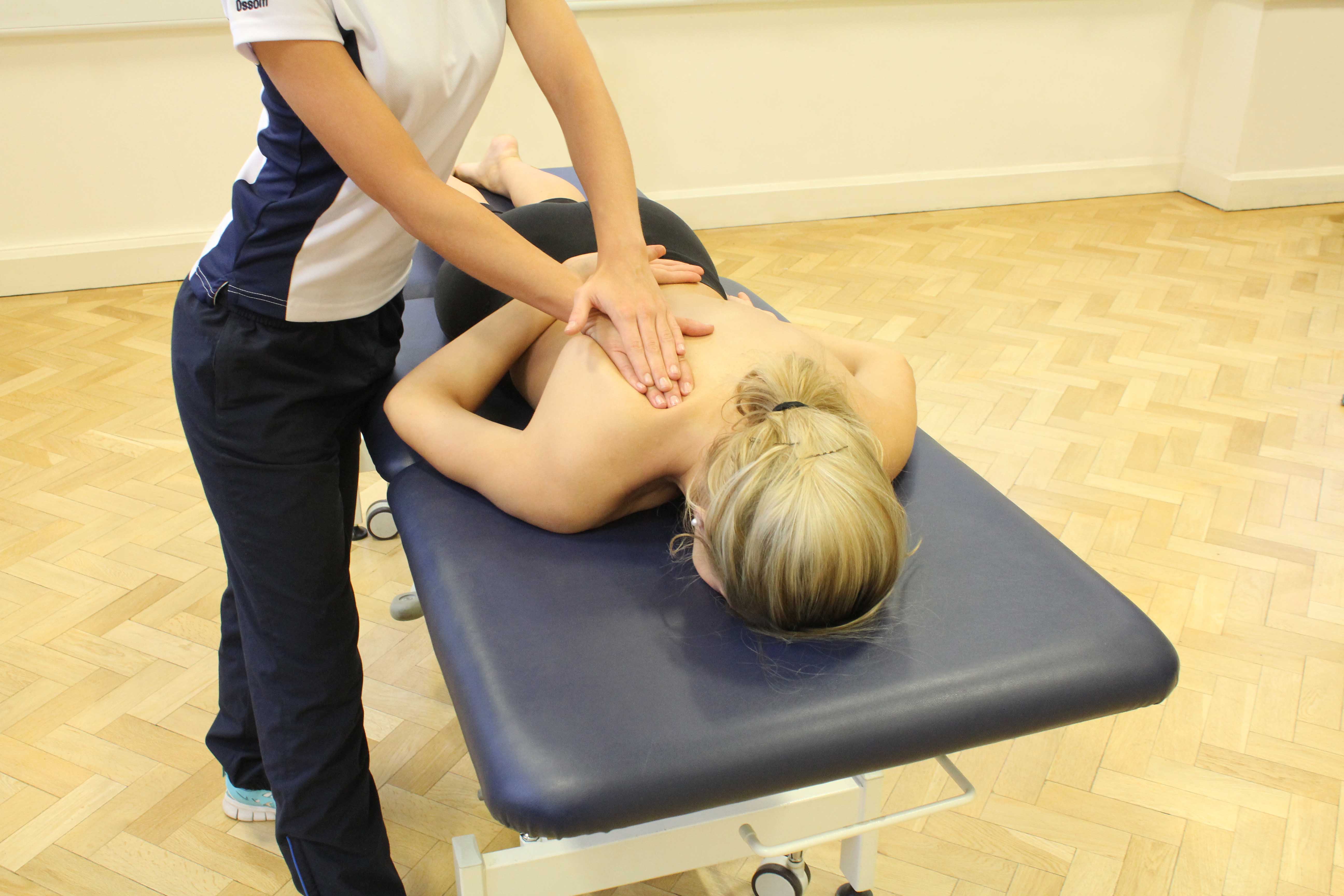 Soft tissue massage of the trapezius muscles to reliev pain and stiffness