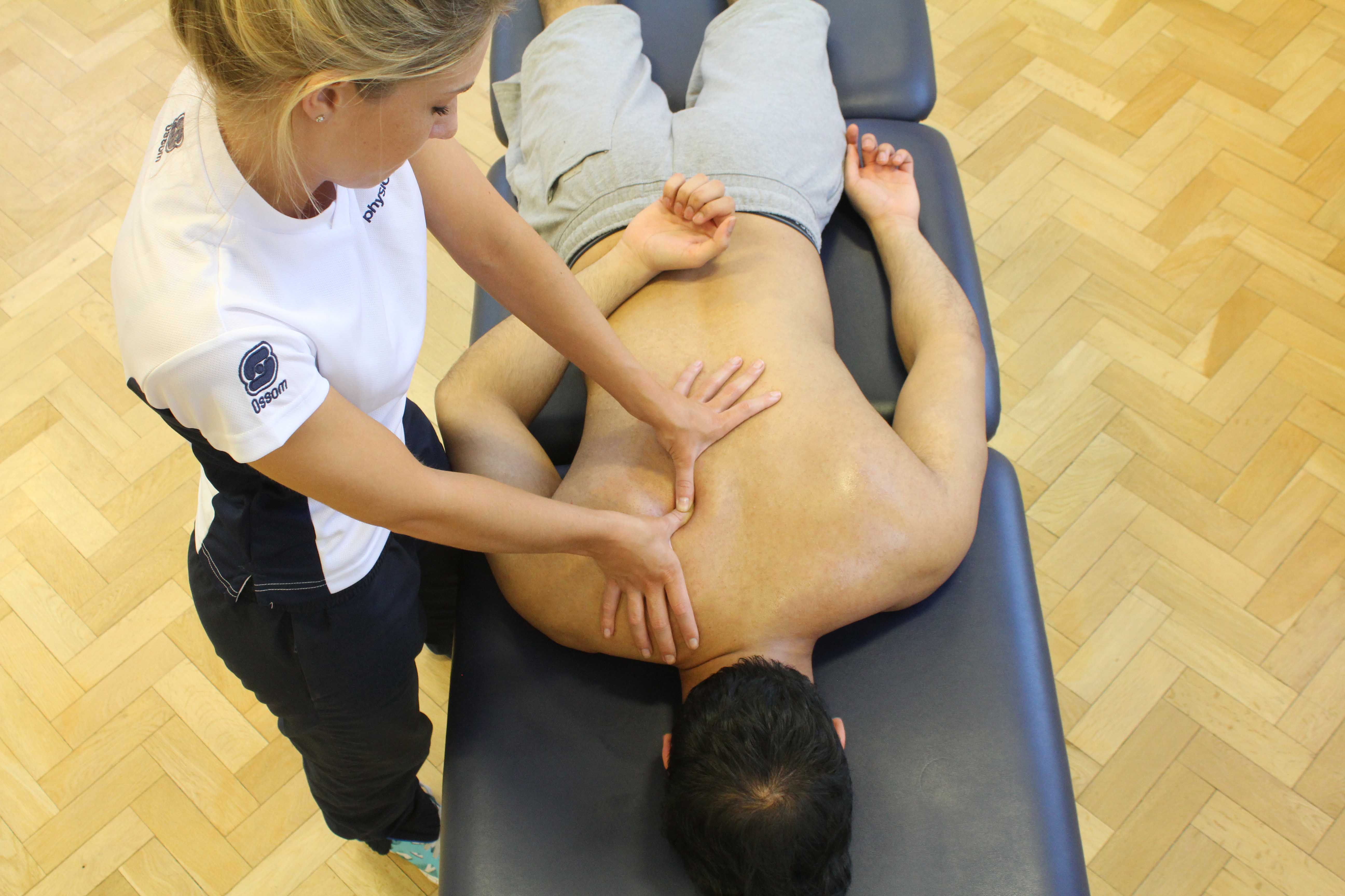 Trigger point massage of the muscles in the upper back
