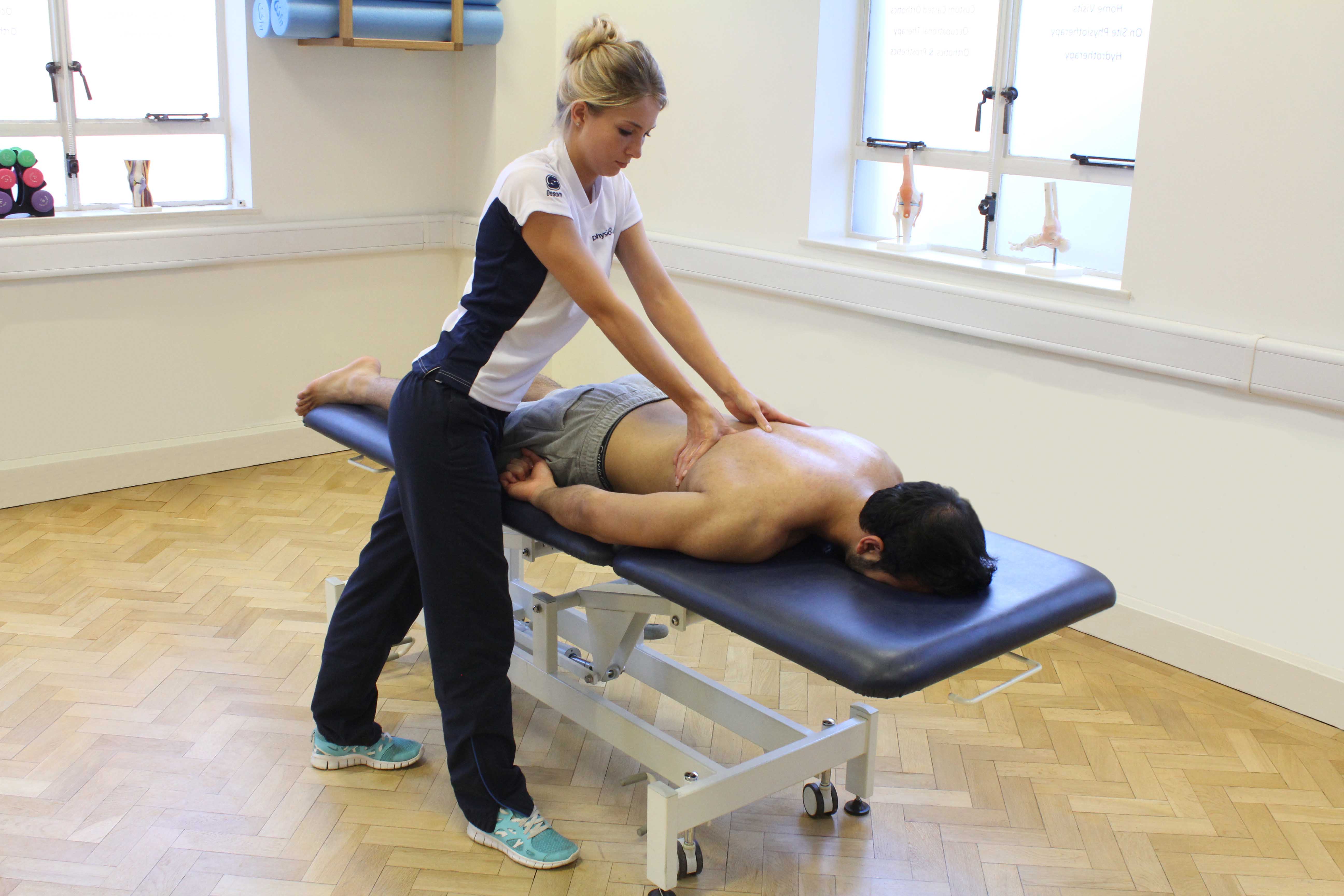 Trigger point massage of the thoracic vertebrea to relieve pain and stiffness