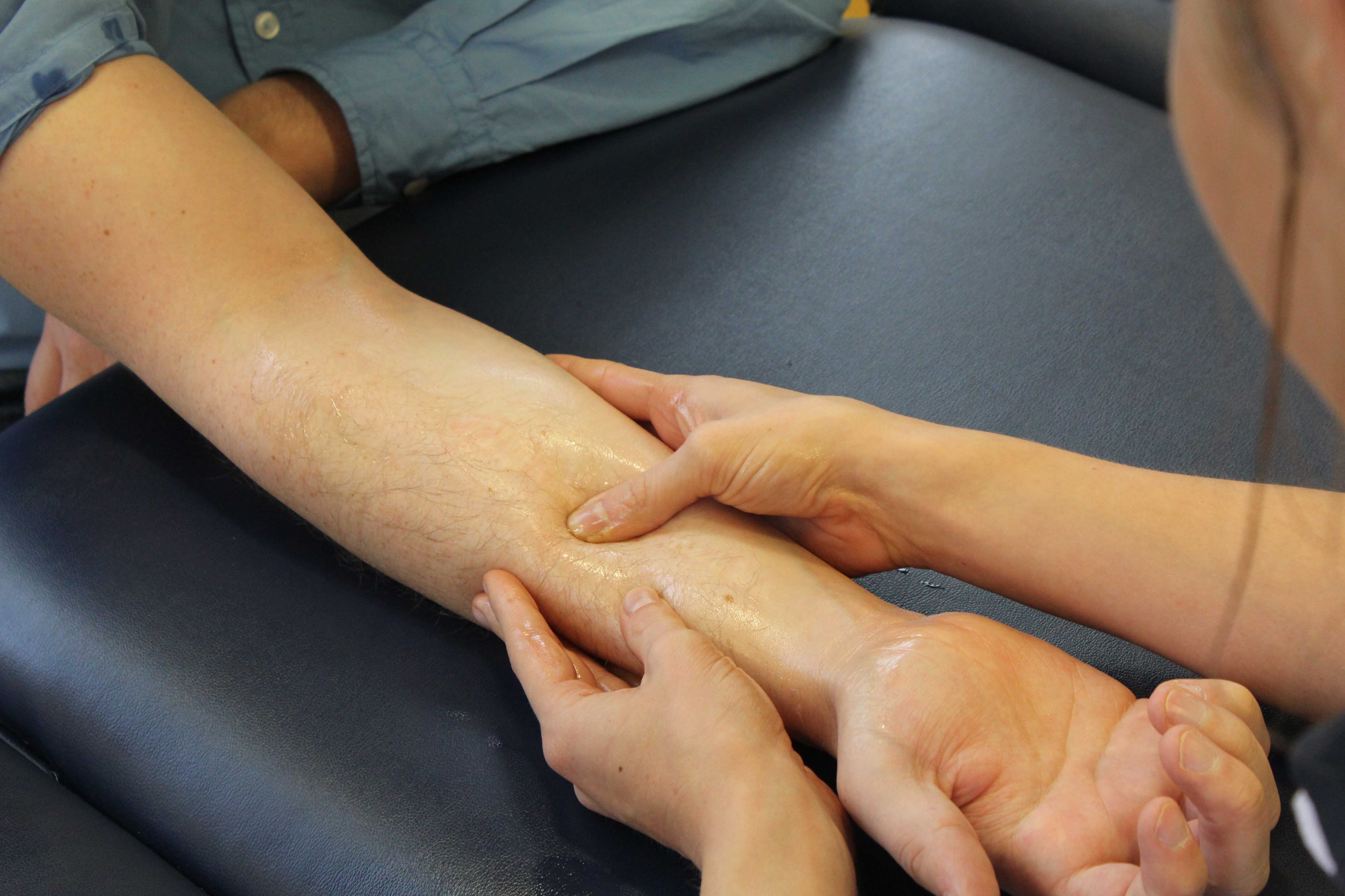 Soft tissue massage of the forearm focusing on flexor muscles