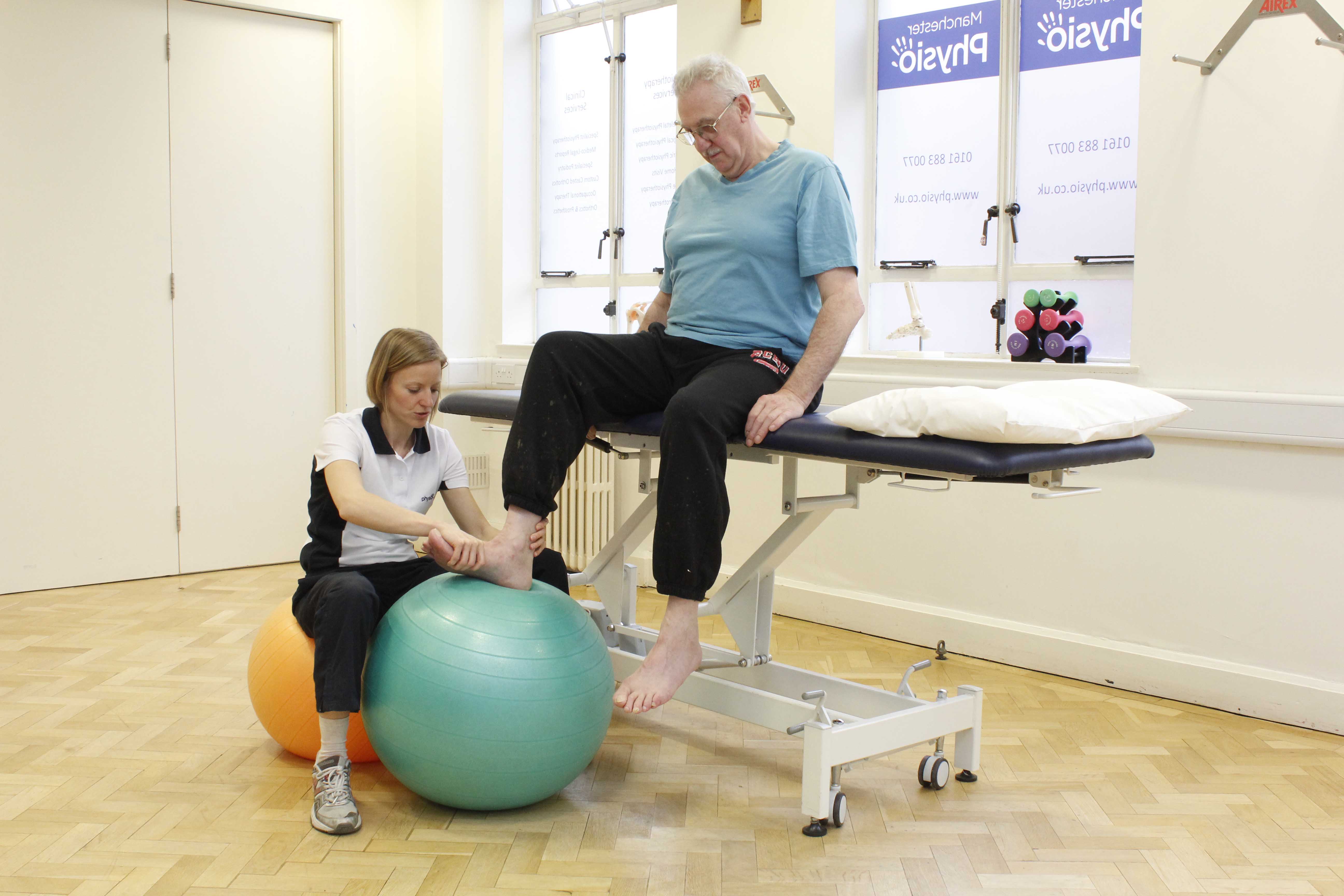 Experienced physiotherapist assisting with some ankle dorsiflexion exercises