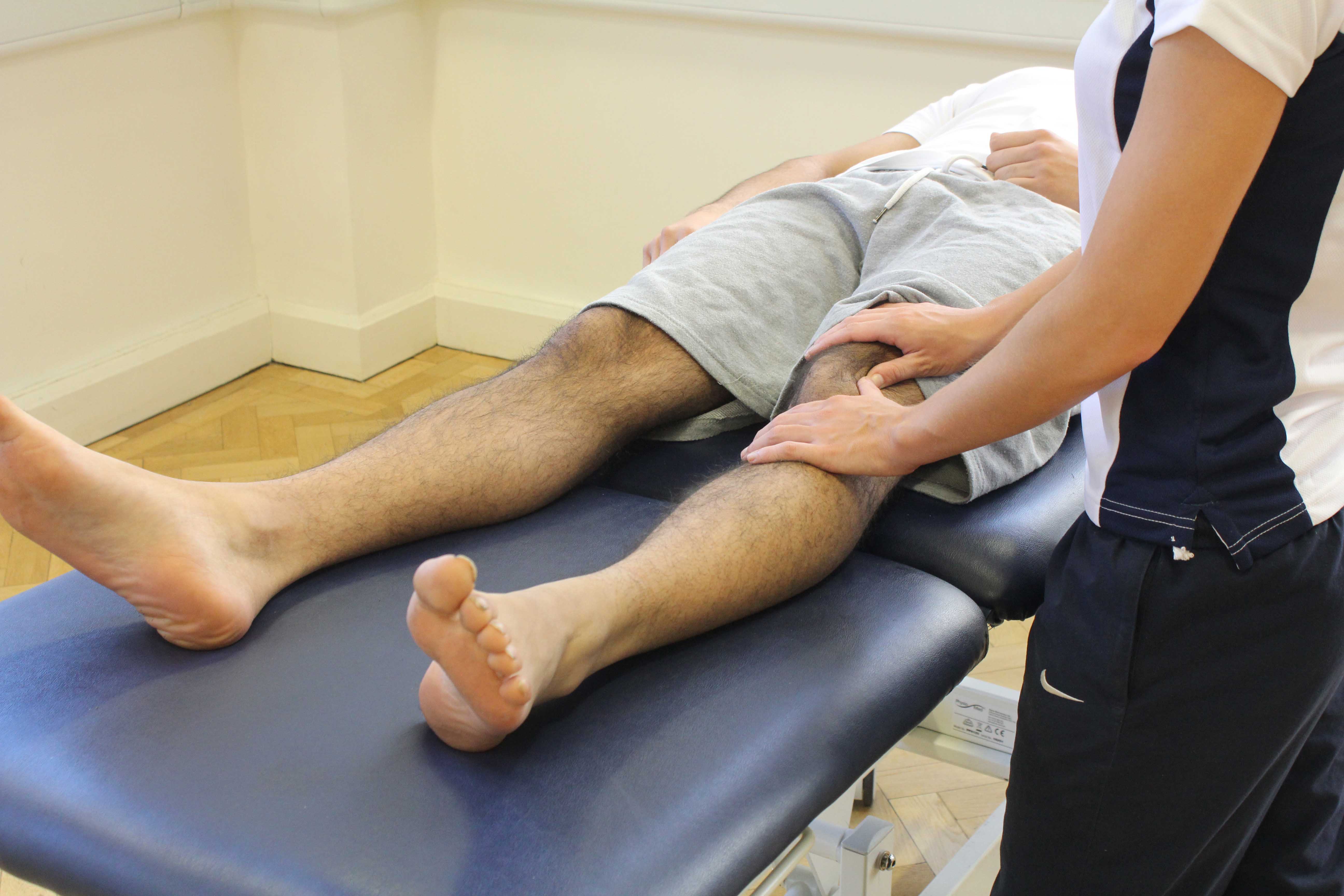Therapist performing soft tissue massage and mobilisations on the patella and surrounding connective tissue.