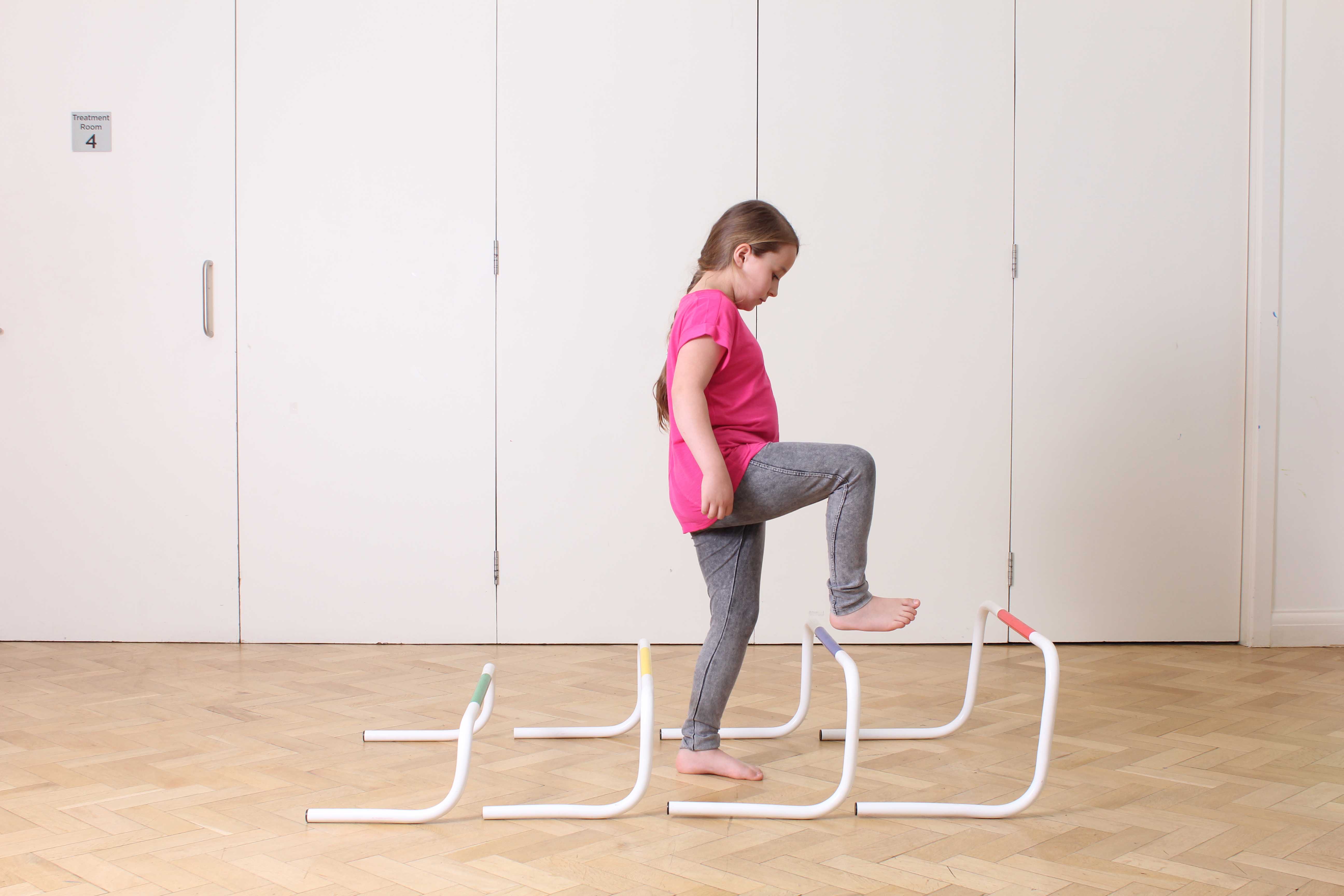 Gait re-education exercises between the parallel bars supervised by a paediatric physiotherapist