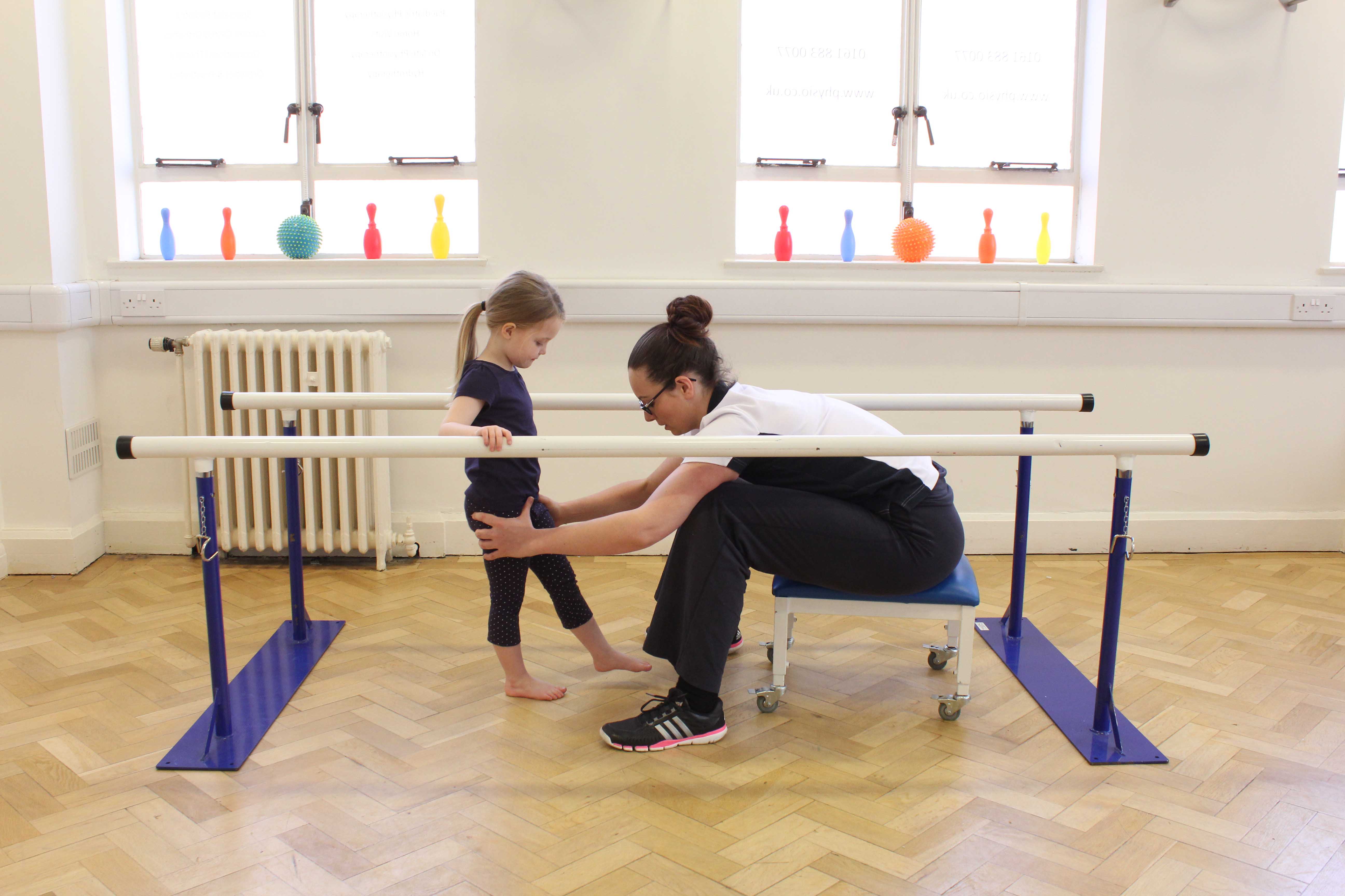 Gait re-education using the parallel bars under close supervision of specilist Paediatric Physiotherapist