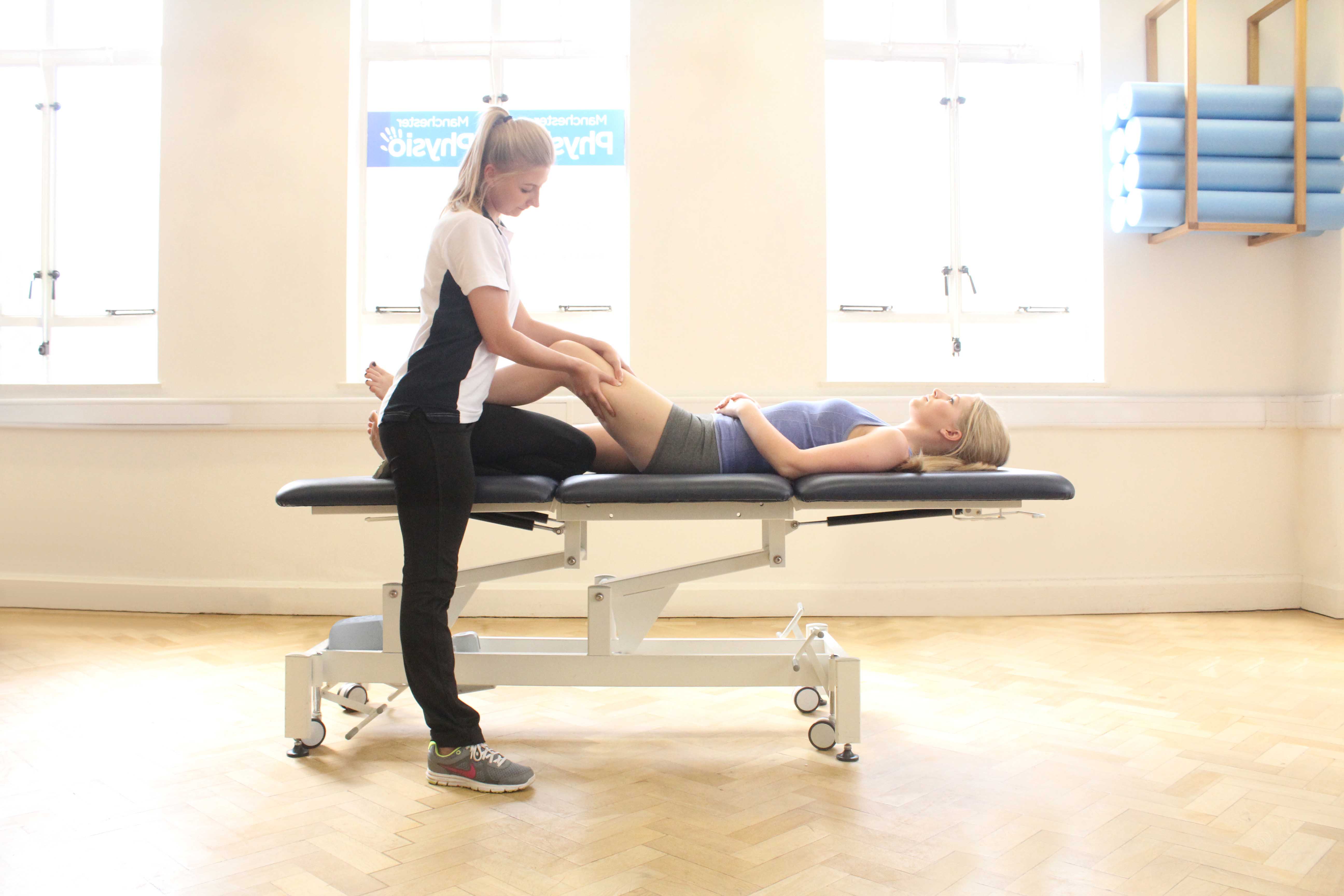 Trigger point massage applied to the quadricep muscles