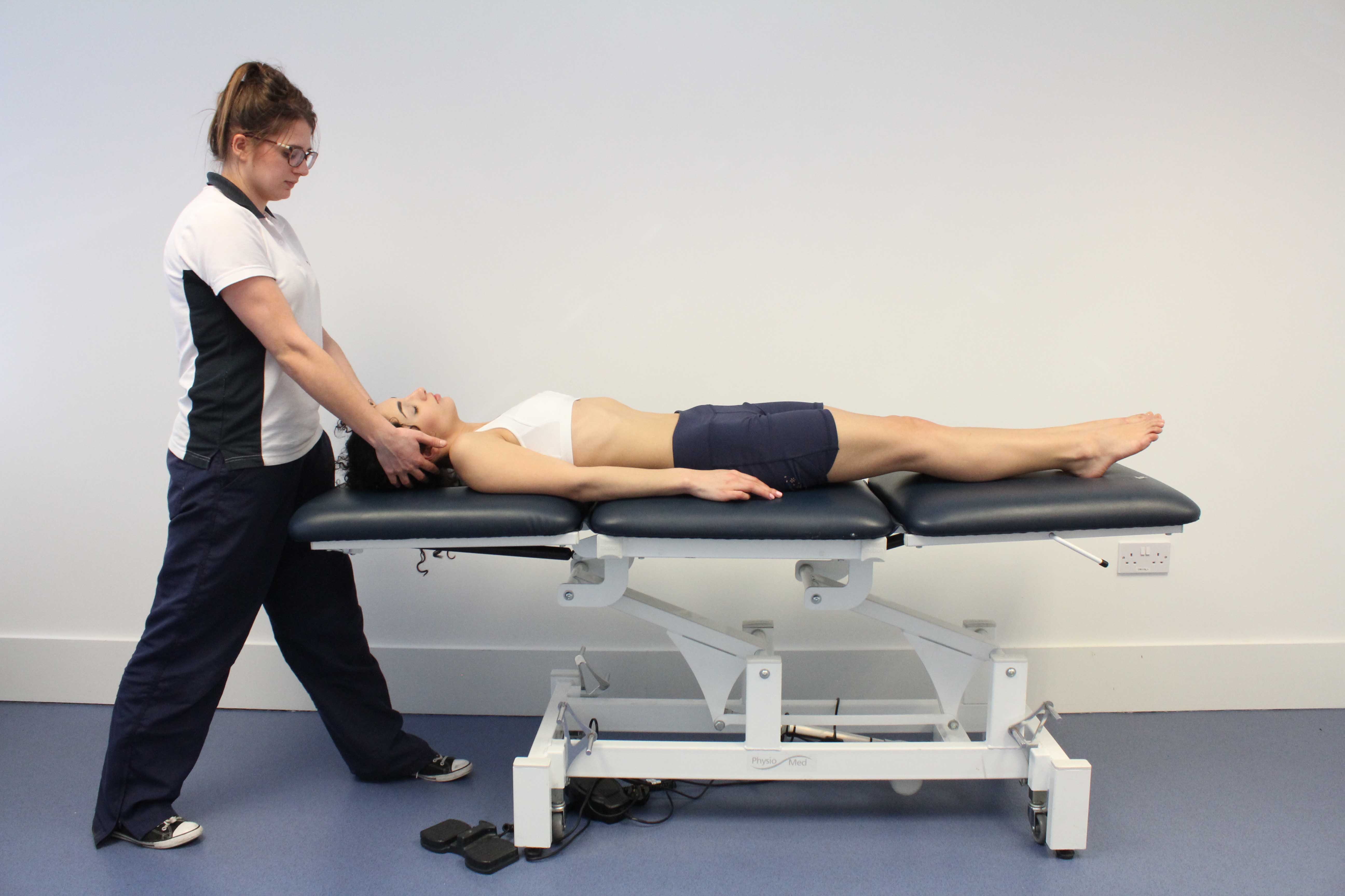 Passive stretches and mobilisations by a physiotherapist of muscle and cervical vertebrea to relieve stiffness and pain