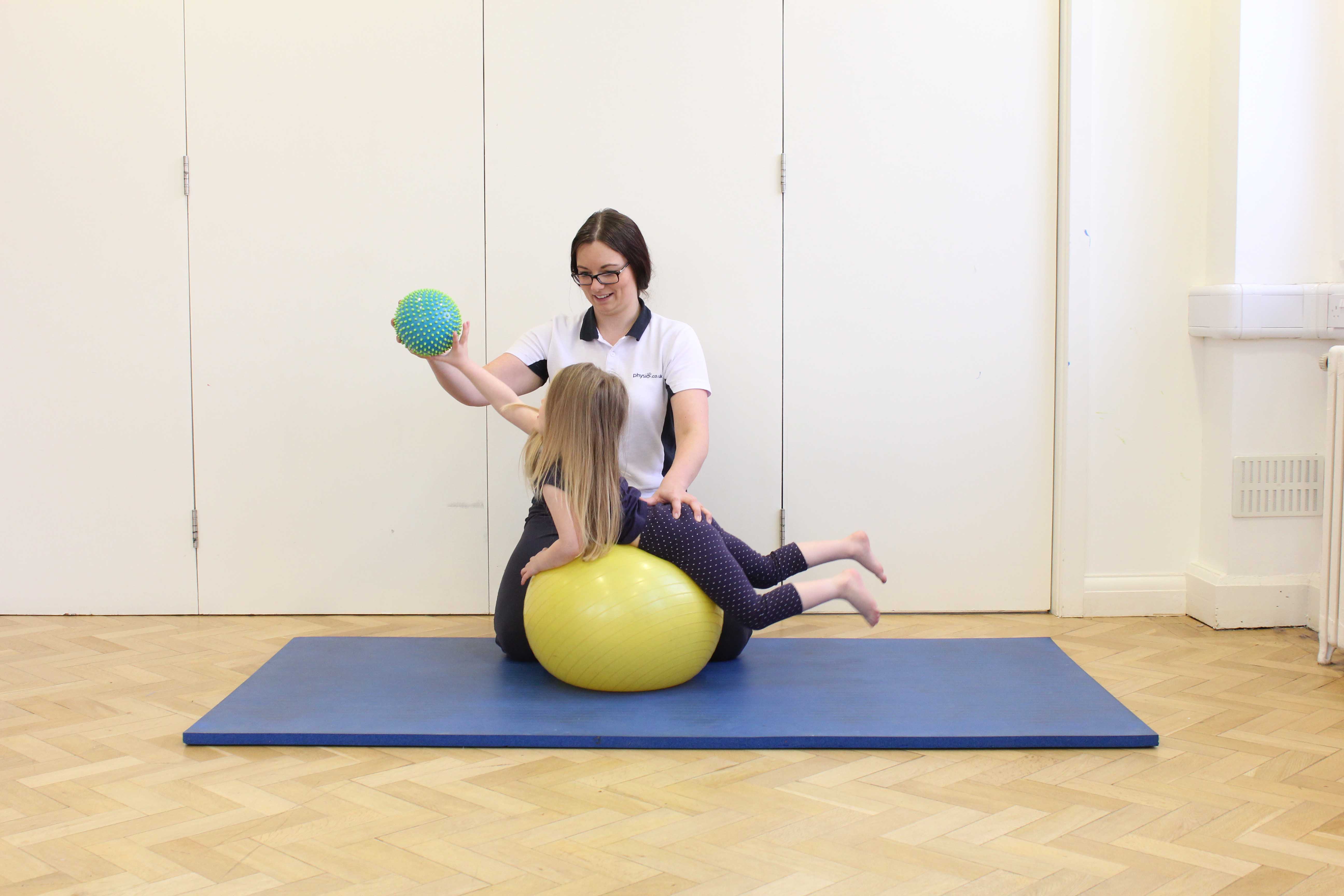 Active stretching exercises over a gym ball under close supervision of specialist paediatric physiotherapist