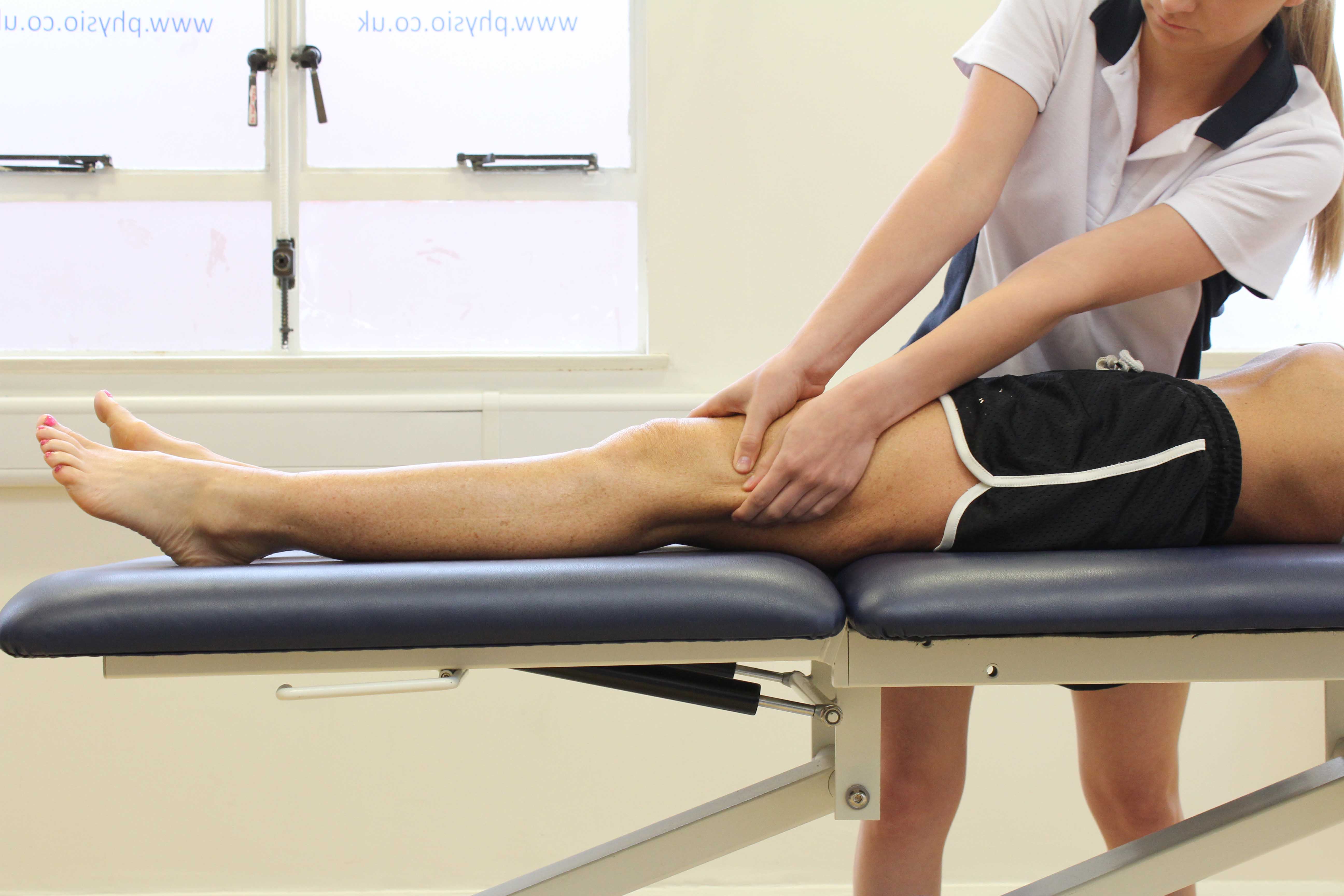 Soft tissue massage of the muscle and connective tissues around the knee