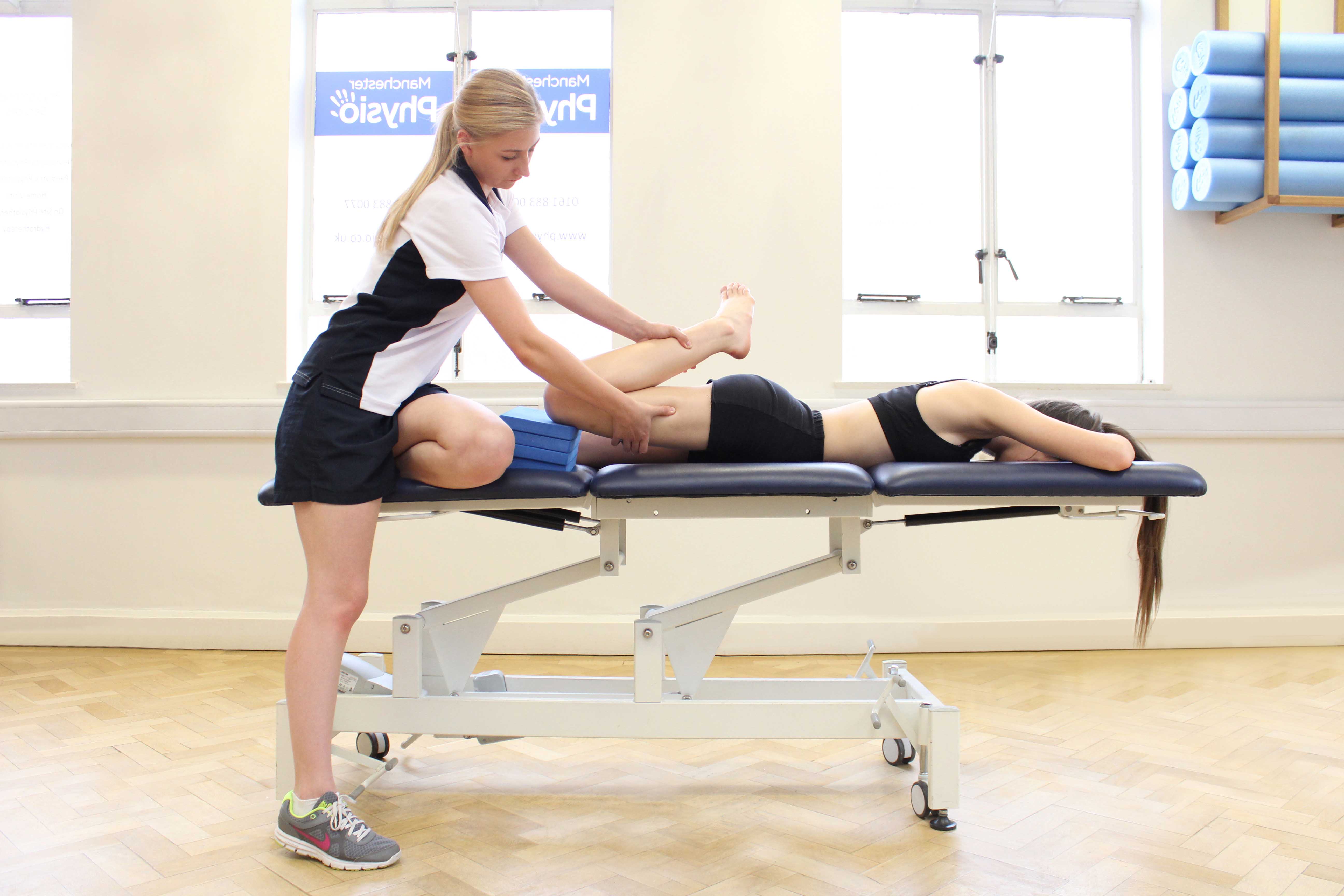 Passive stretch of the muscles and connective tissues of the hip by specialist therapist