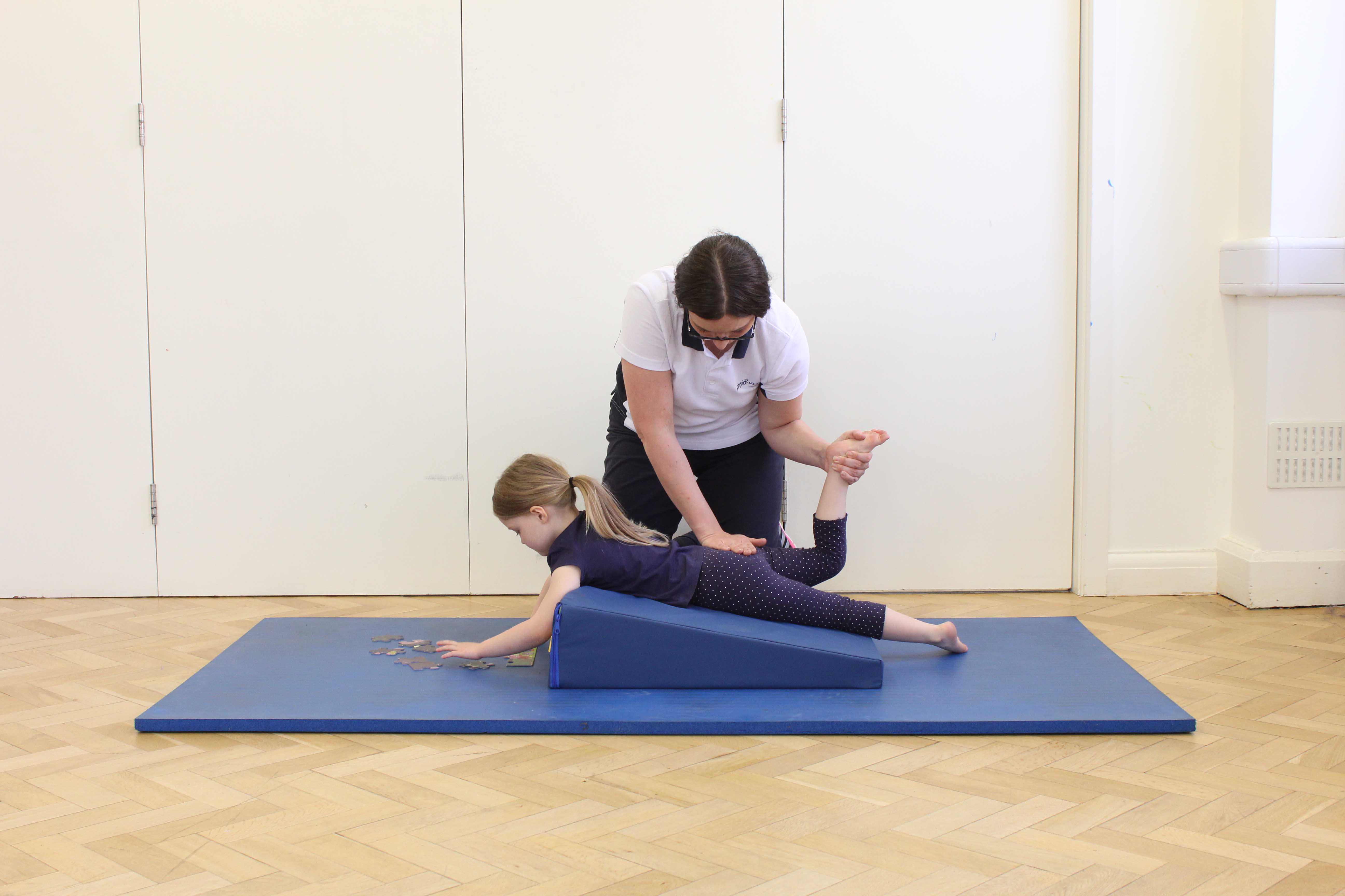 Massage and stretches of the hip and knee applied by a specialist paediatric physiotherapist