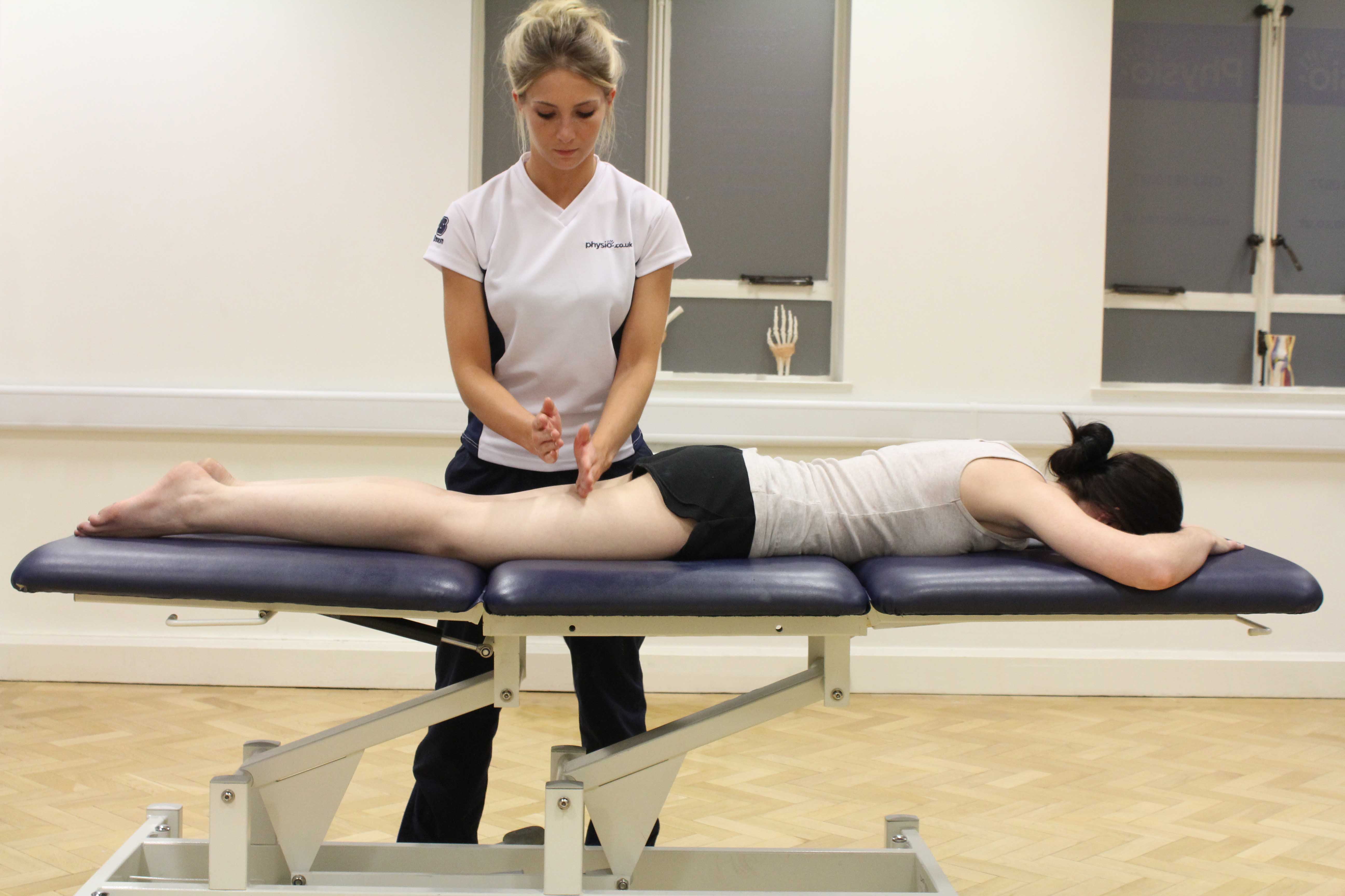 Hacking percussion massage technique applied to hamstring muscles by a specialist massage therapist