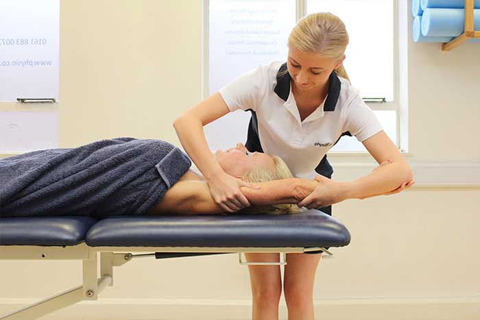 Customer reciving arm massage while in relaxed position in Manchester Physio Clinic