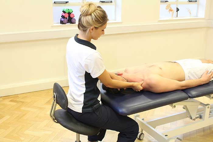 Customer receiving upper shoulder massage, in a relaxed position