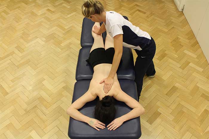 Customer reciving upper back massage in a relaxed position in Manchester Physio Clinic