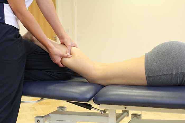 Customer recieveing a calf massage in Manchester Physio Clinic