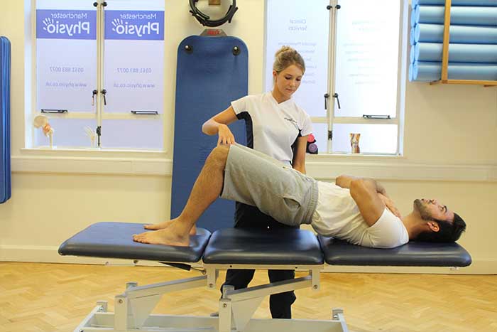 Customer increasing flexibility Customer maintaining back stretches in Manchester Physio Clinic in Manchester Physio Clinic