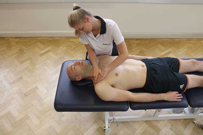 Customer reciving upper shoulder massage in Manchester Physio Clinic